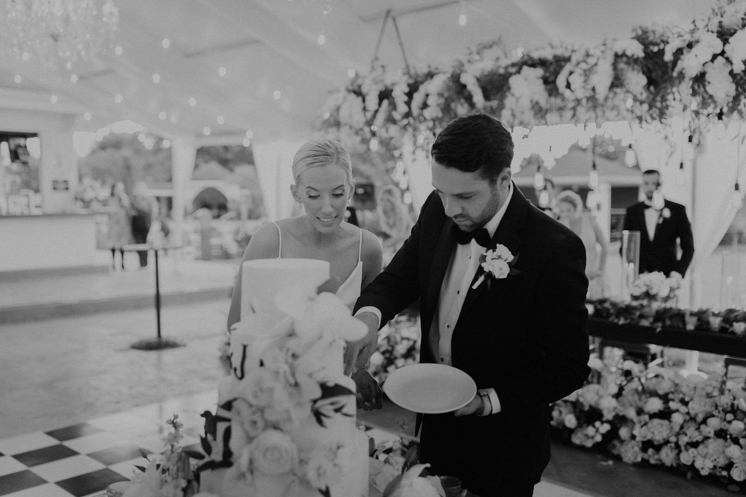 Couple sharing a moment during cake cutting at their wedding reception.