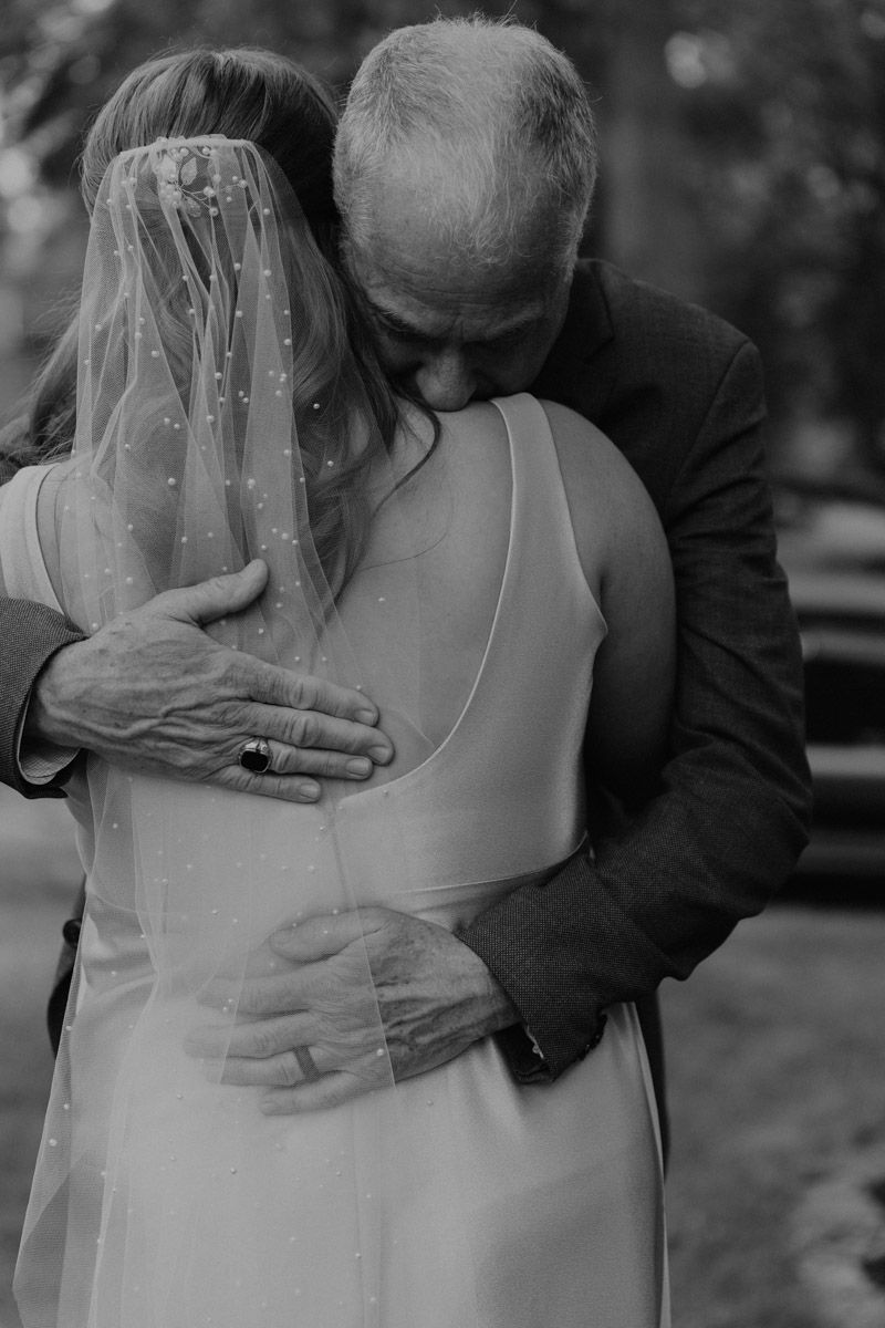 Black and white series showing tender embraces during a wedding ceremony.