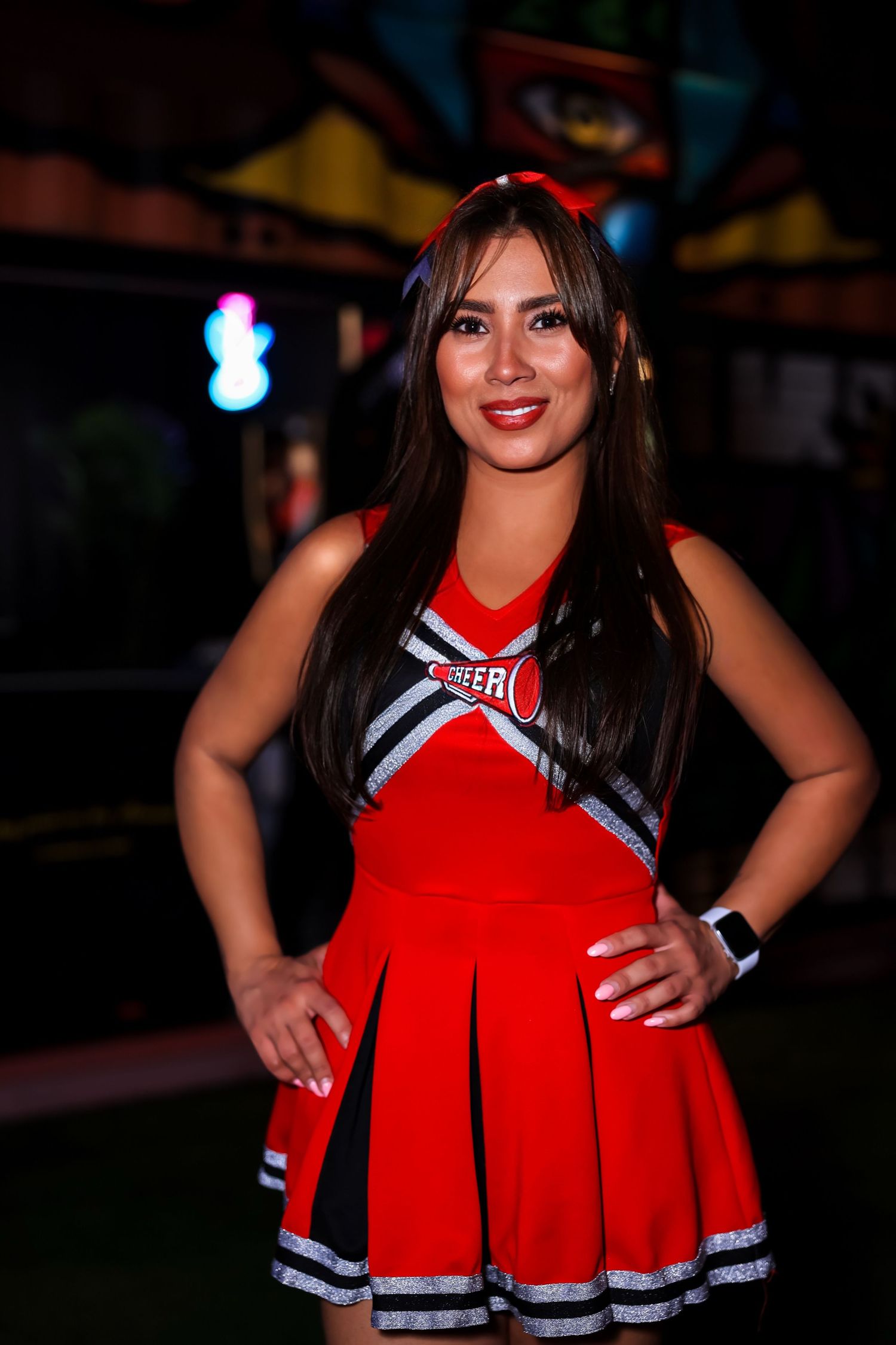 Red and white cheerleader uniform displayed in multiple poses against a dark background.