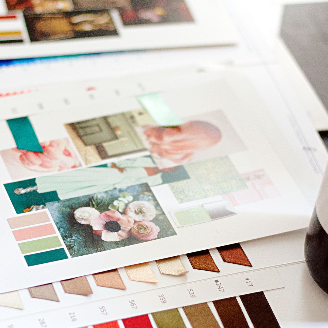 Colorful design swatches and photo layouts arranged on a white surface.