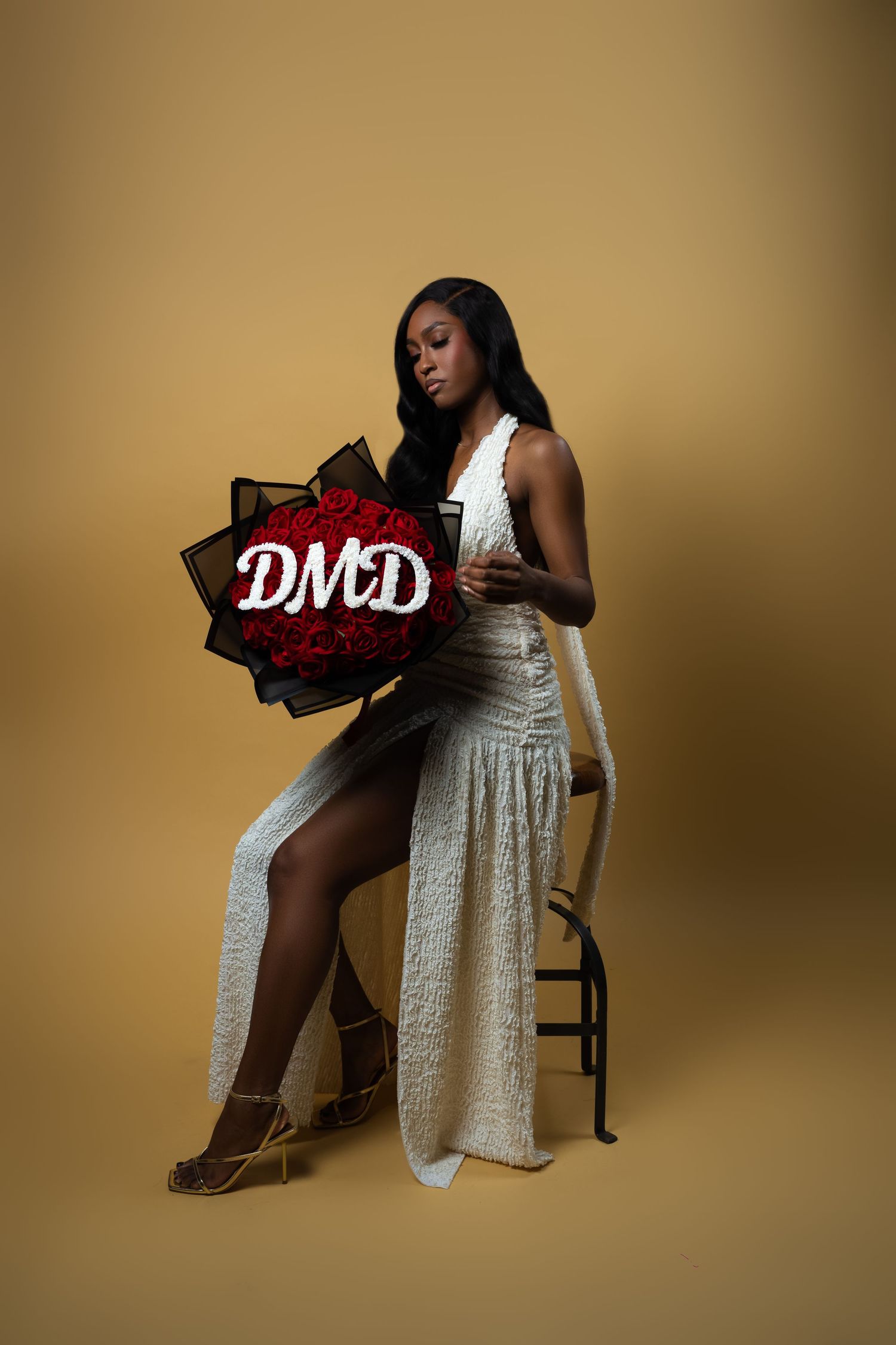 A series of fashion poses in a white dress against a warm brown background in a minimalist studio setting.
