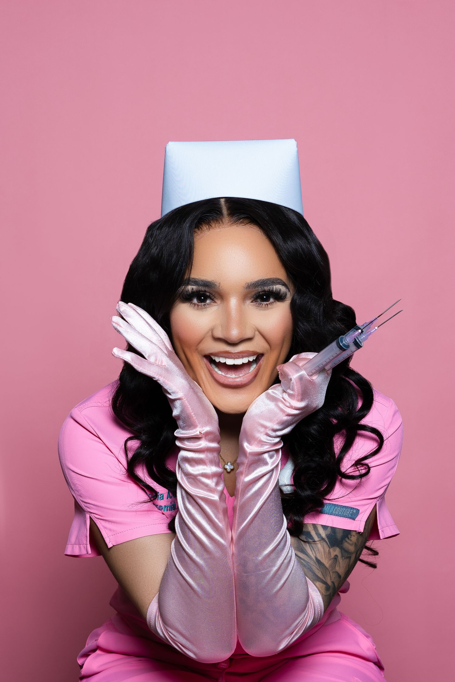 Nurse in pink uniform and white cap showing playful expression with medical tools.
