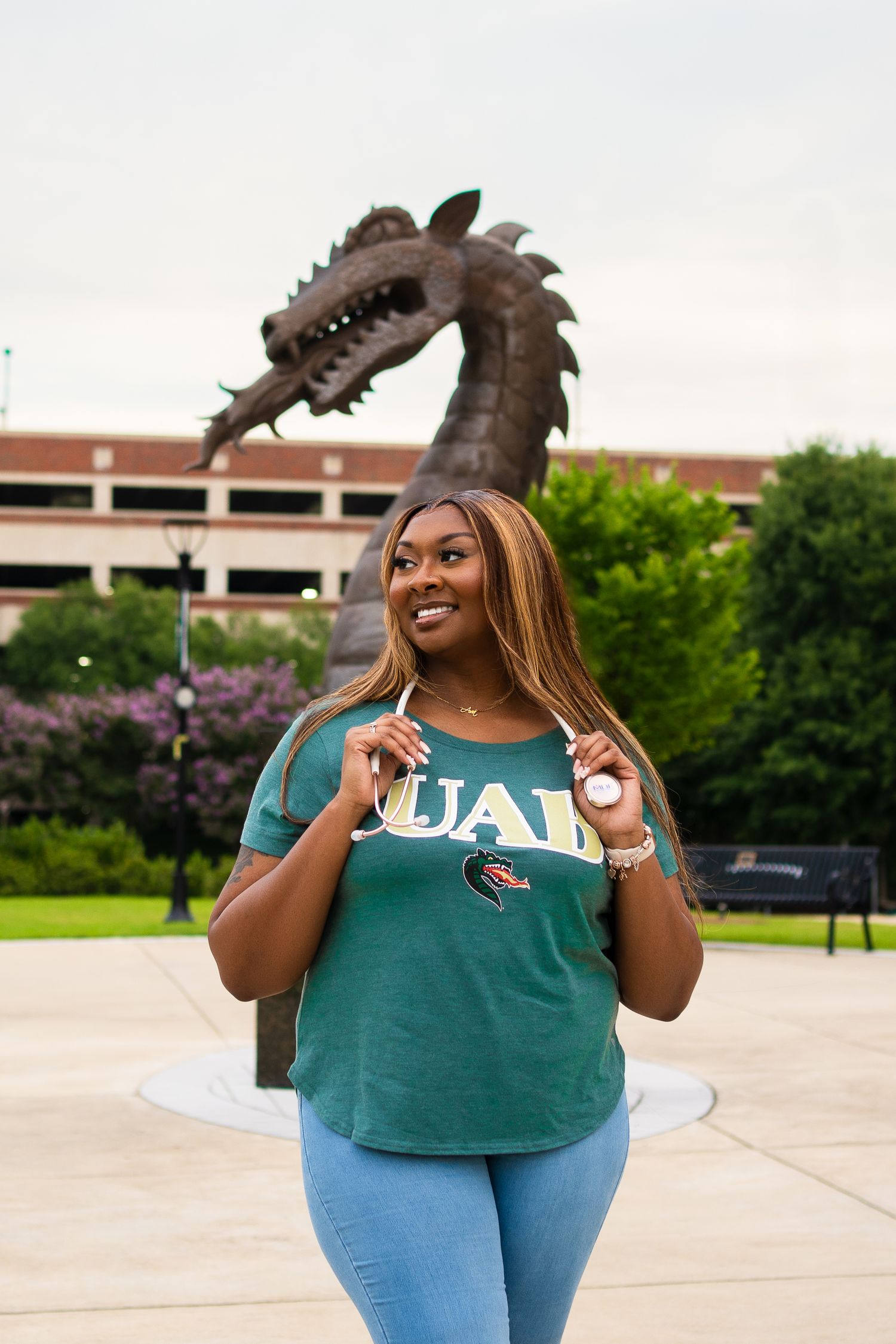 Student in UAB school spirit wear showing excitement on campus.