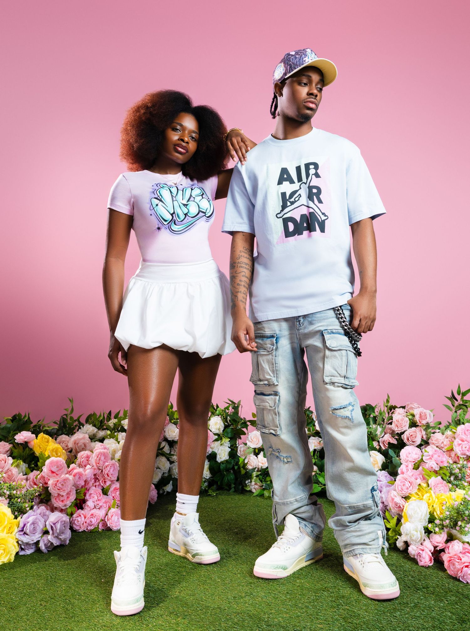 Cropped views of people wearing white shirts and gray cargo pants with white sneakers against a pink backdrop with flowers.