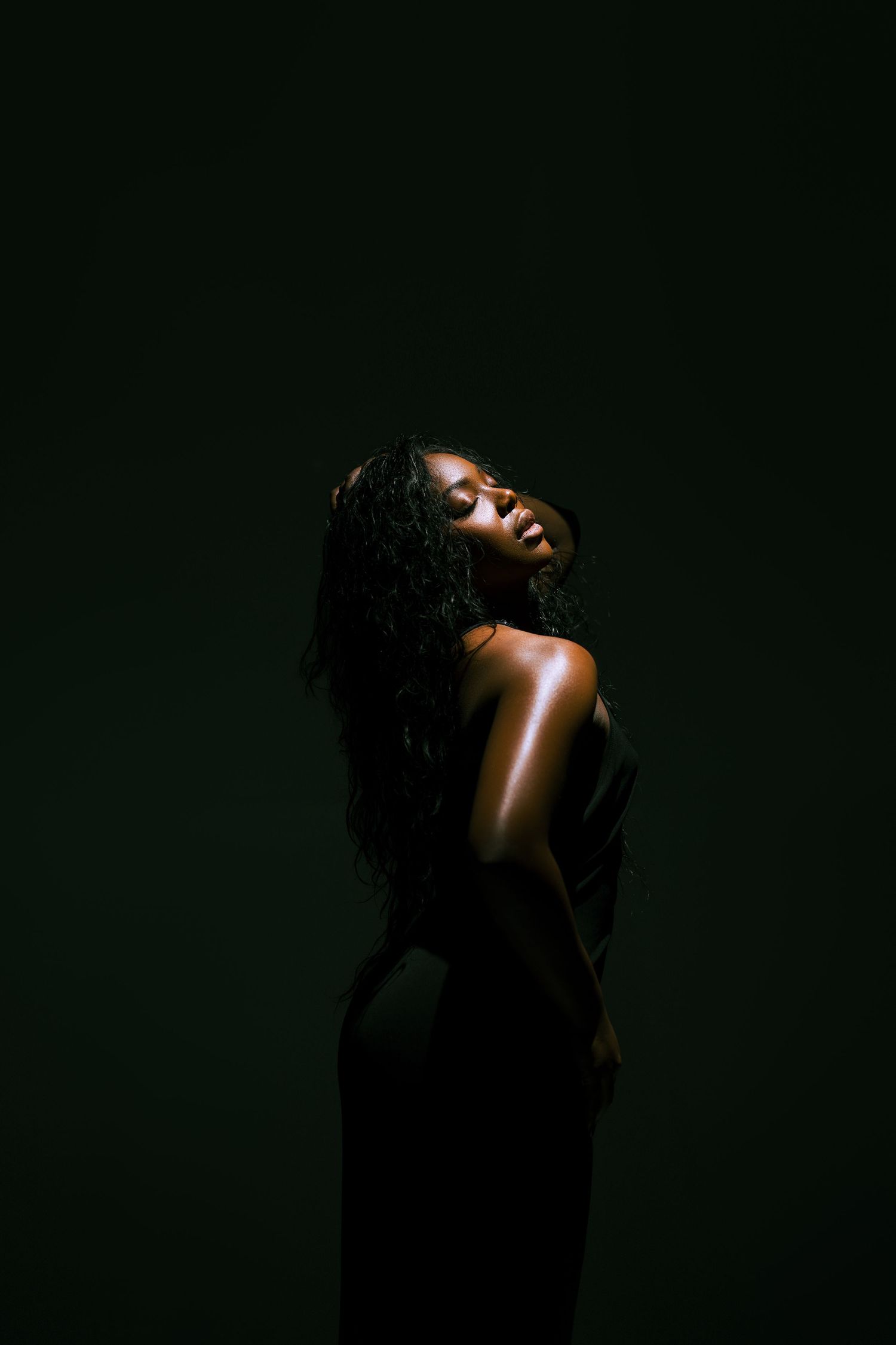 Dramatic portrait series showing a figure in shadow against dark background with artistic lighting effects.