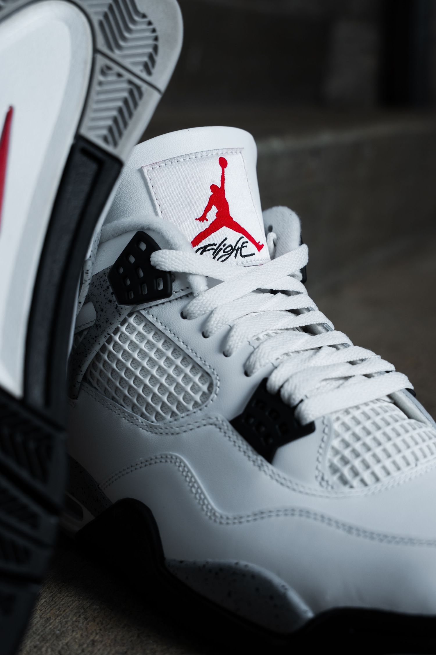 Detailed shots of white Air Jordan sneakers showing textured surfaces and red logo accents.