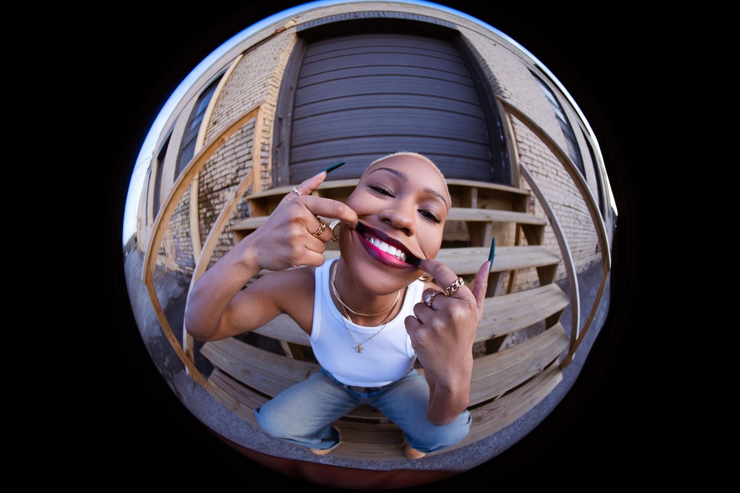 Fisheye lens captures candid moment outside brick building with unique curved perspective.