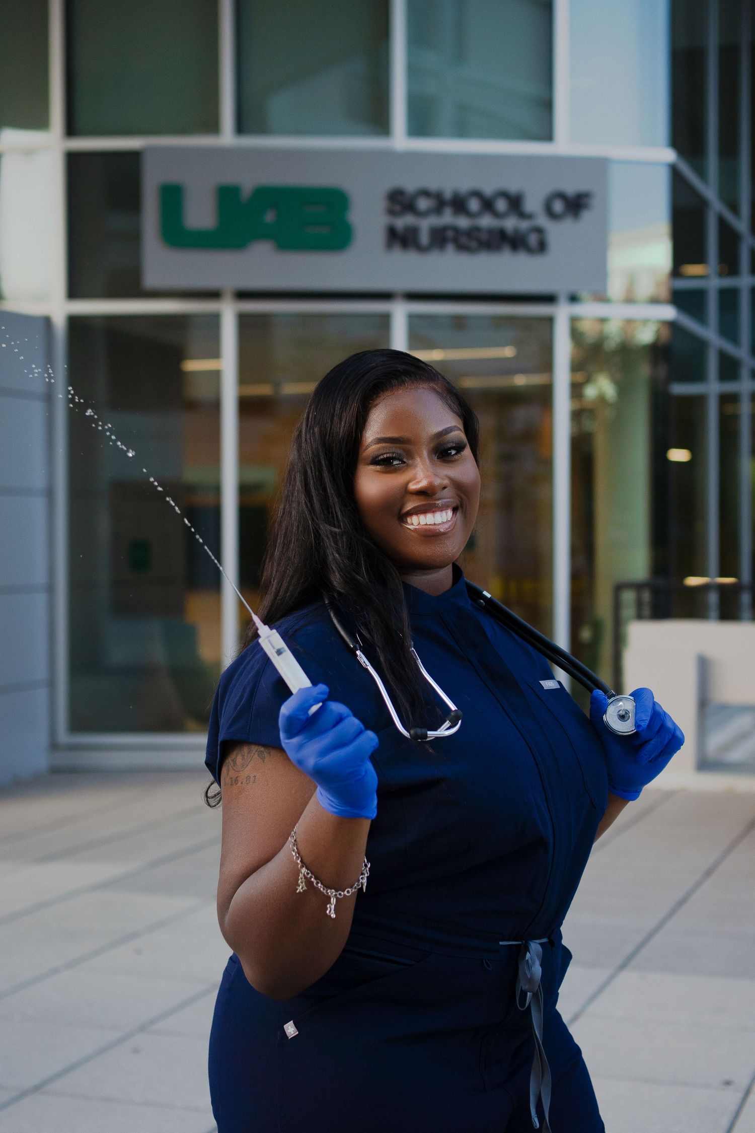 Medical professional with stethoscope celebrating graduation achievement.