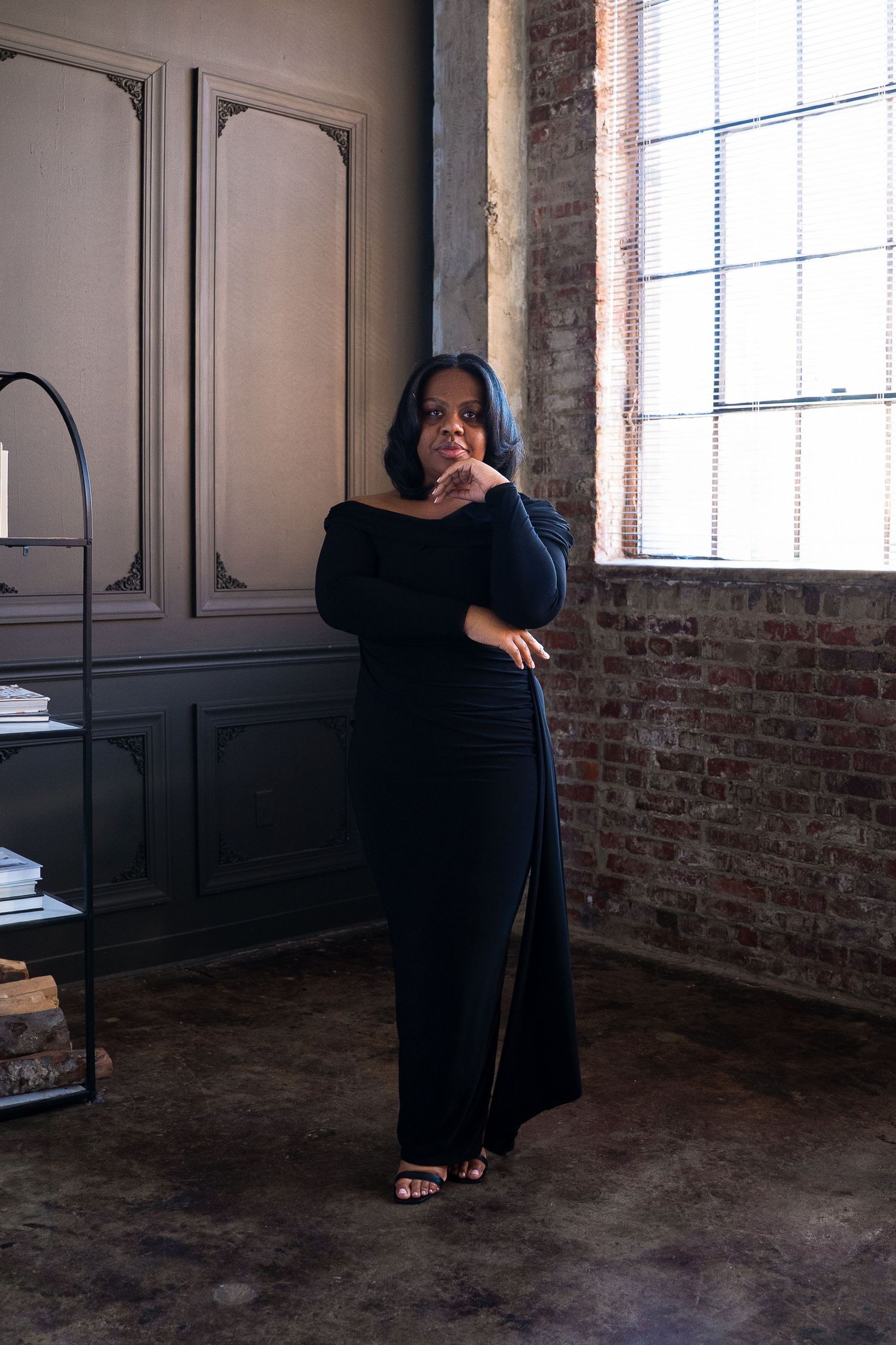 Artistic poses captured in industrial space with exposed brick and window light.