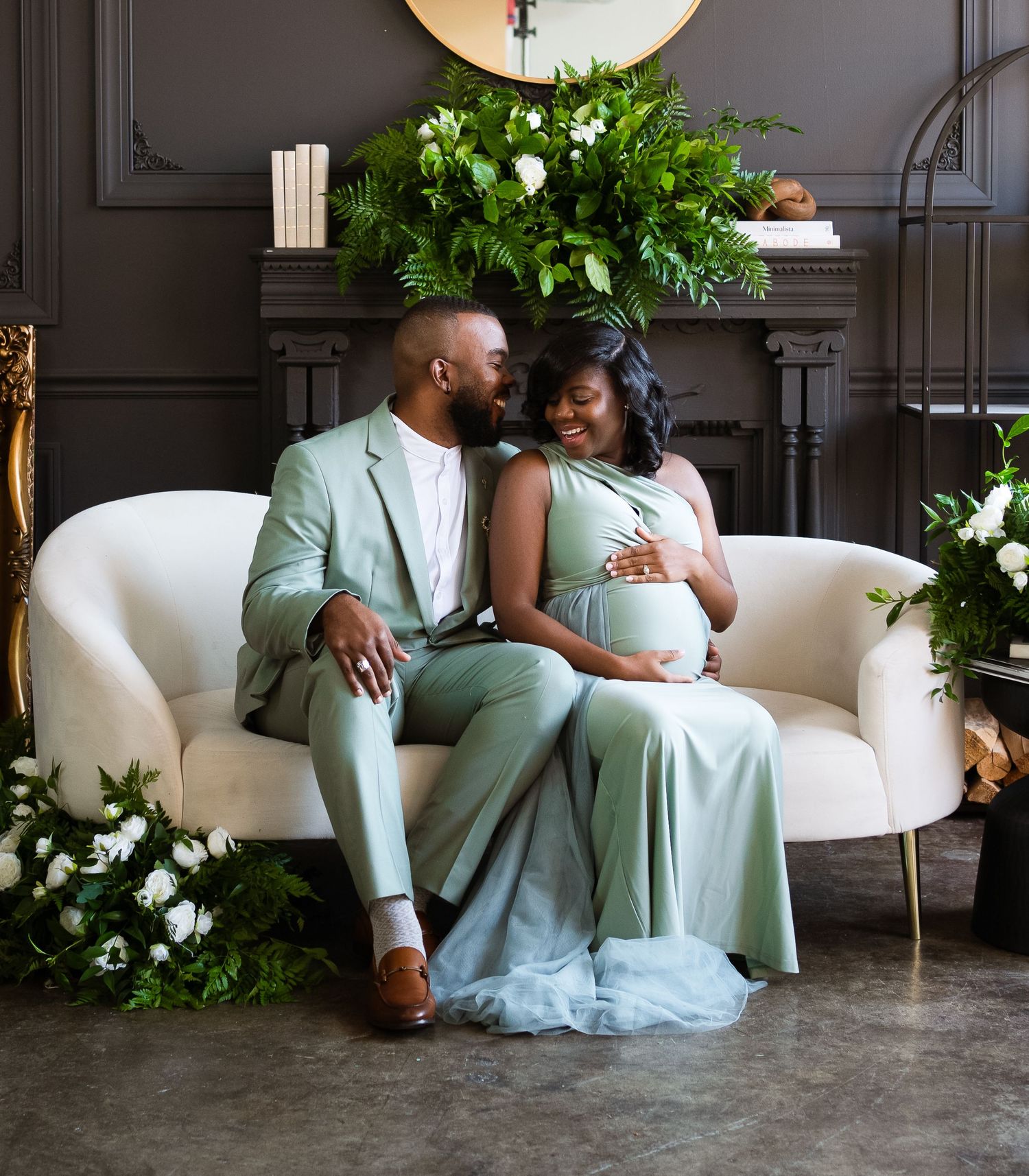 Romantic couple photos on white couch with mint green formal attire and elegant decor.