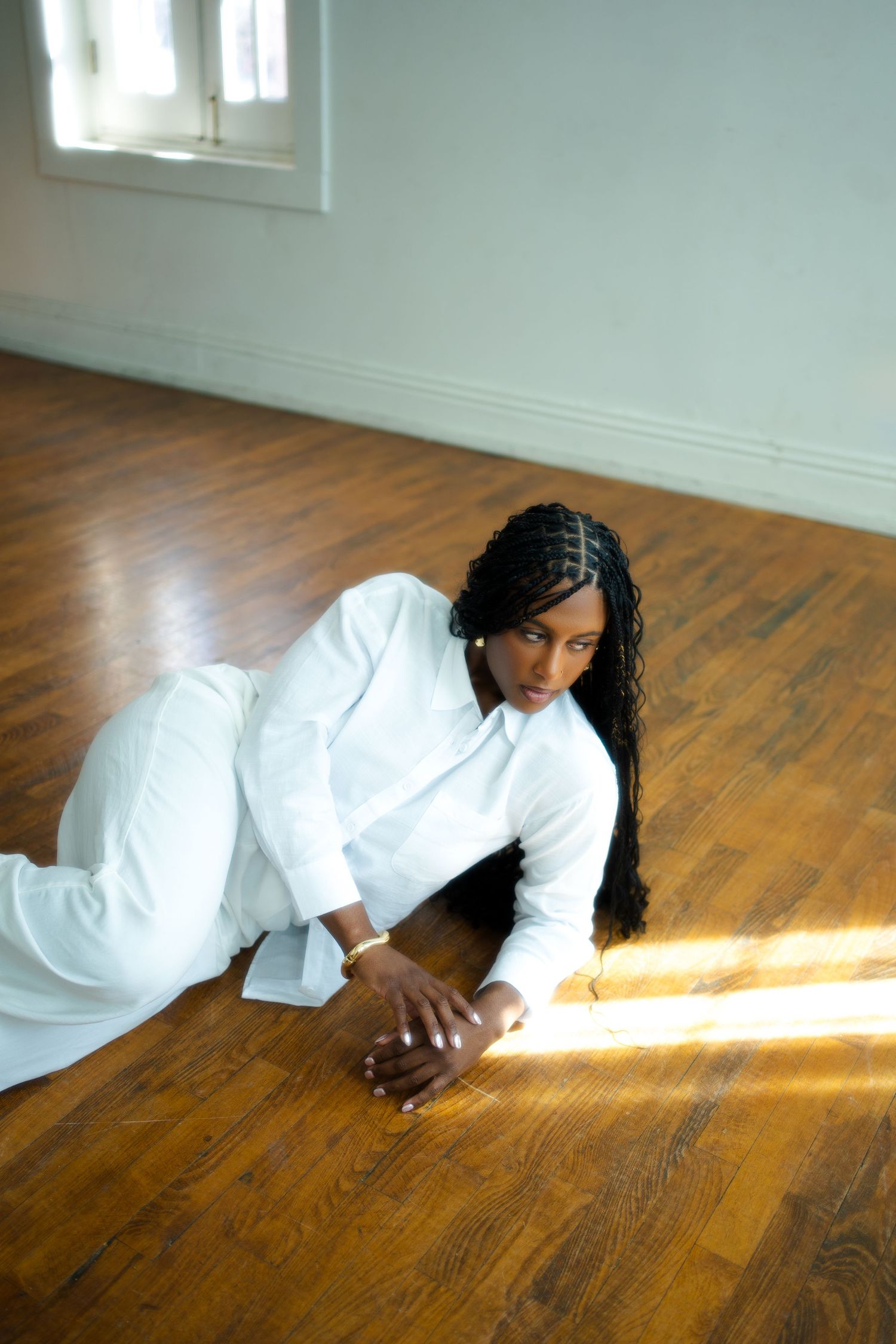 A sequence of photos showing someone in white clothing lying on a wooden floor with sunlight streaming in through a window.