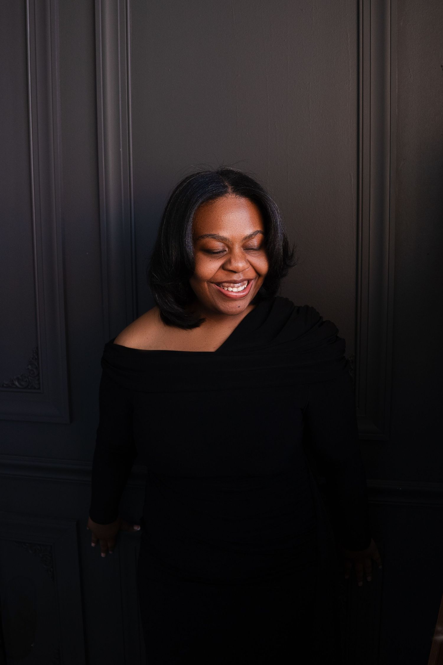Low-key portrait series against dark paneled wall showing joyful expressions.