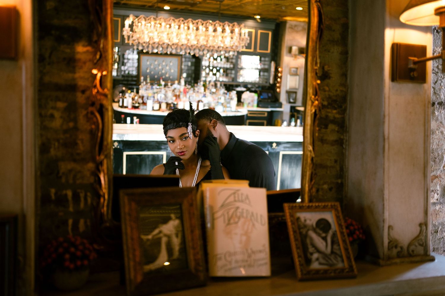 A dimly lit vintage bar interior with glass bottles and wooden decor.