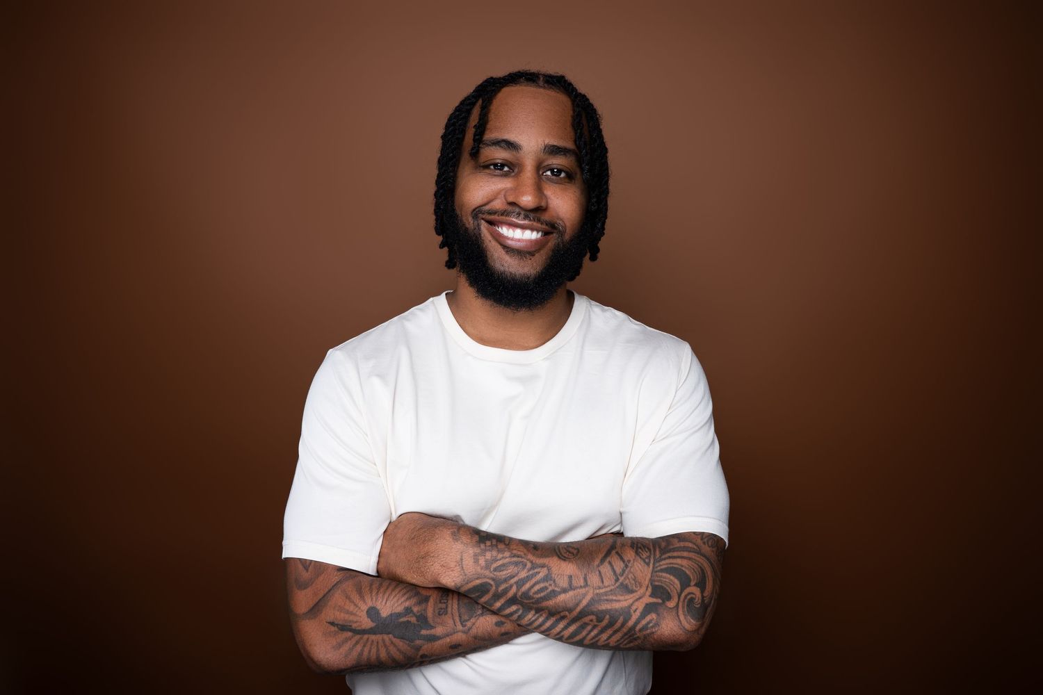 A smiling person wearing a white t-shirt poses against a dark brown background in a photo collage.