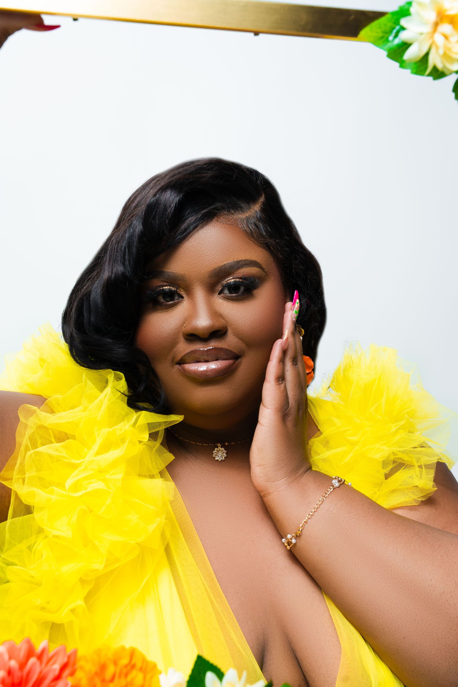 A glamour portrait featuring bright yellow tulle accessories against a light background.