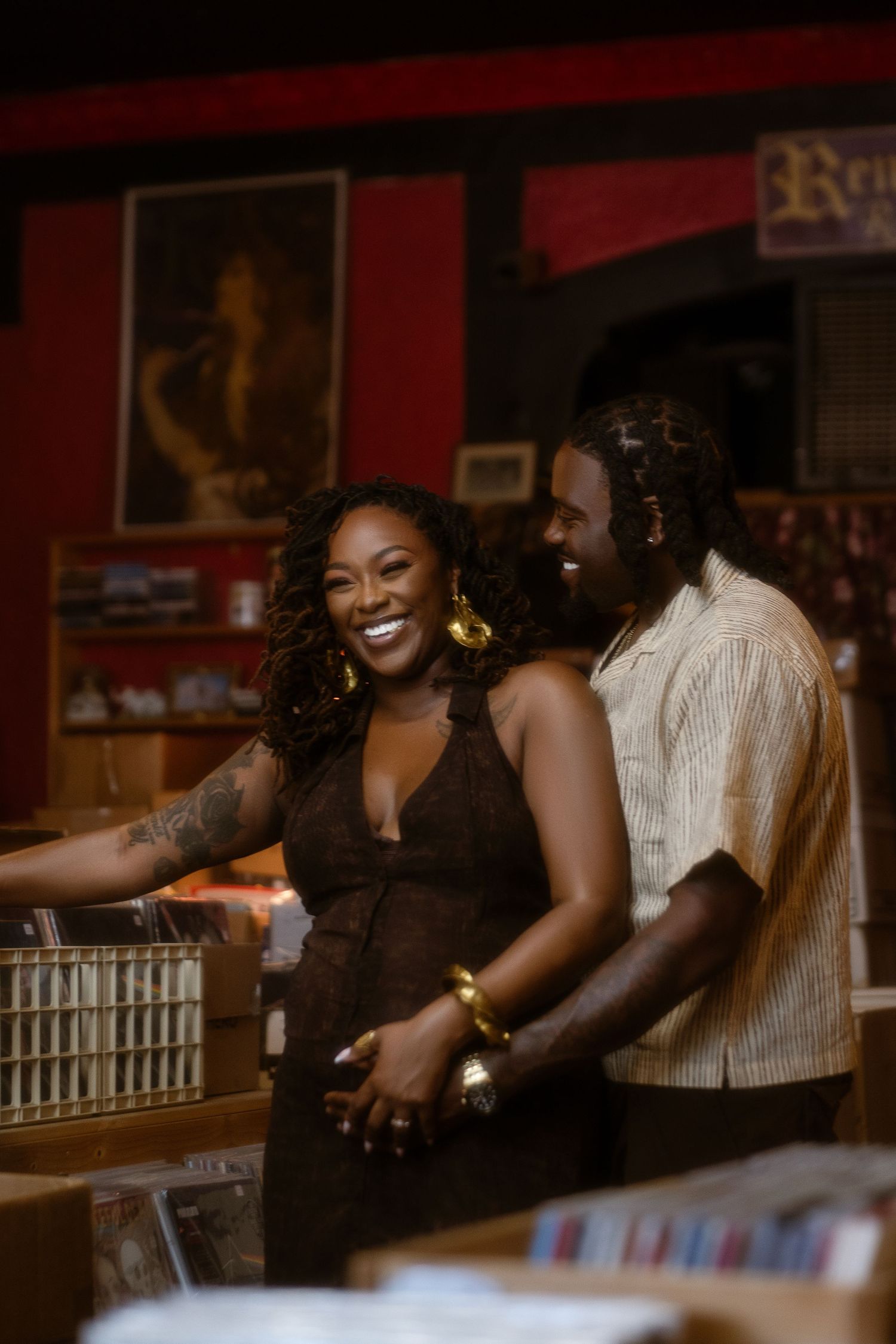 A joyful couple enjoying a moment together in a casual setting with red walls.