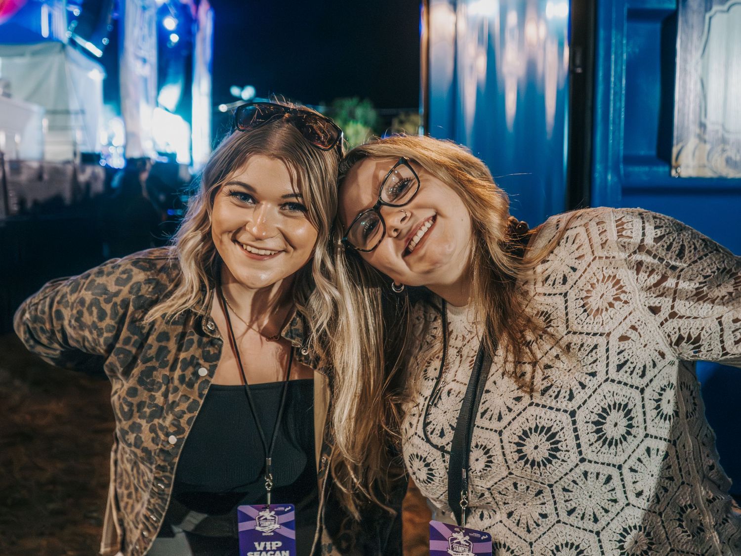 Friends enjoying a night out together at a dimly lit venue with blue lighting.