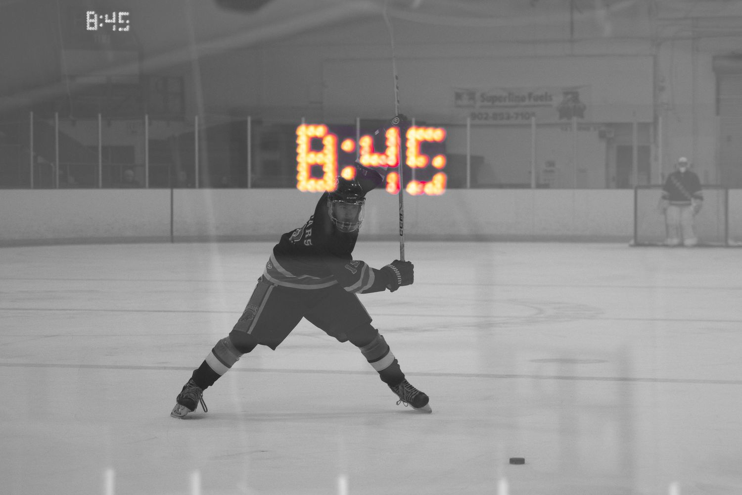 A sequence of hockey players in action shown in black and white photos on an ice rink during gameplay.