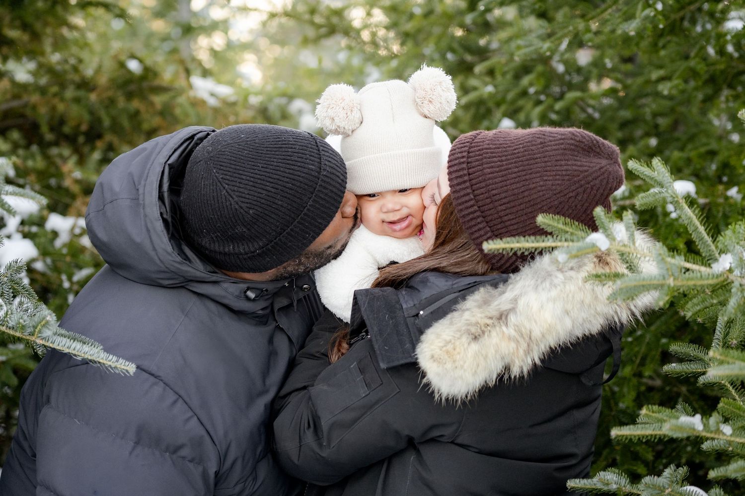 A series of black and white photos showing a romantic outdoor winter engagement photoshoot in a snowy forest setting.
