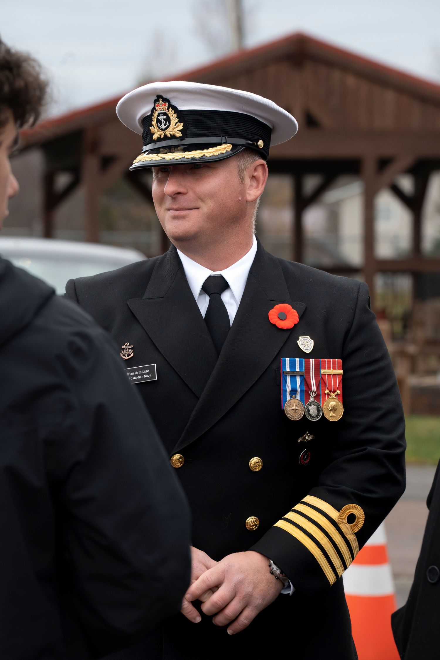 Naval officer in formal uniform with medals and decorations.