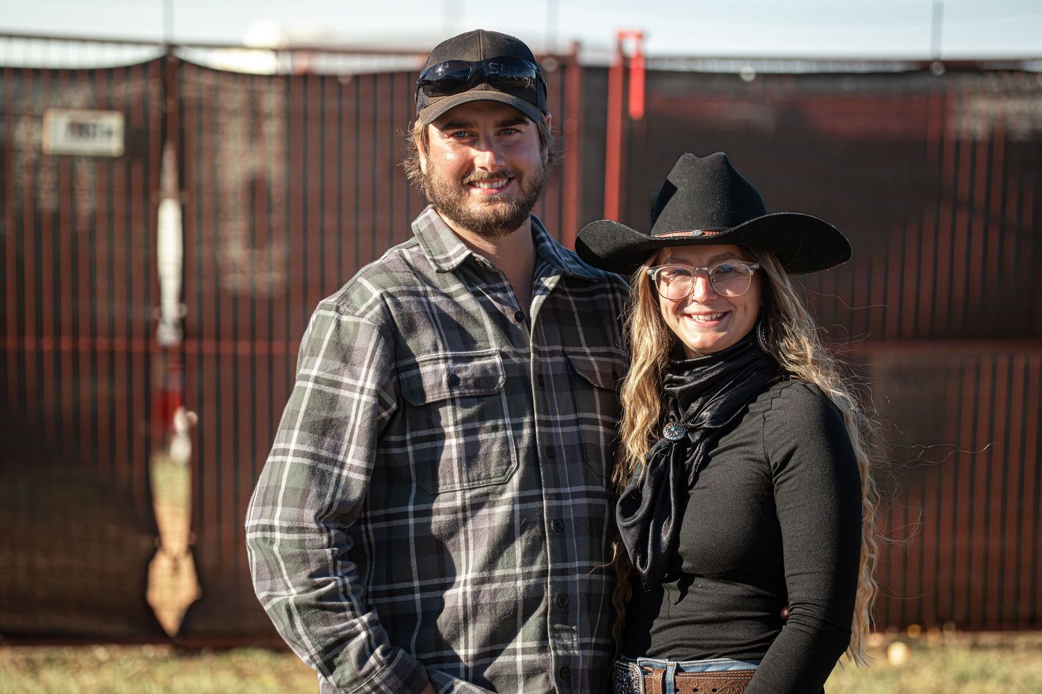 Group photo of people in casual western attire standing together outdoors.