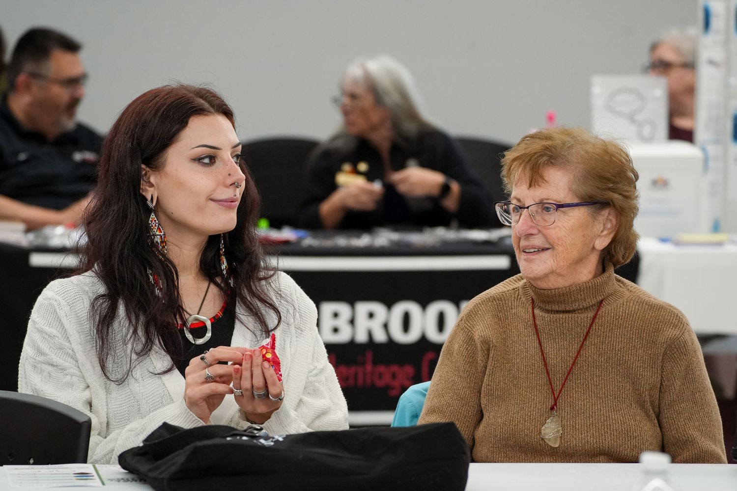 People sitting at tables during a professional meeting or conference.