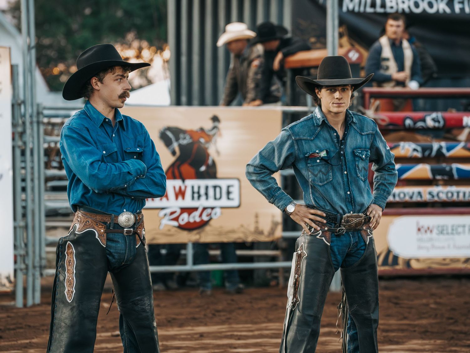 Rodeo participants in denim and western wear preparing for competition.