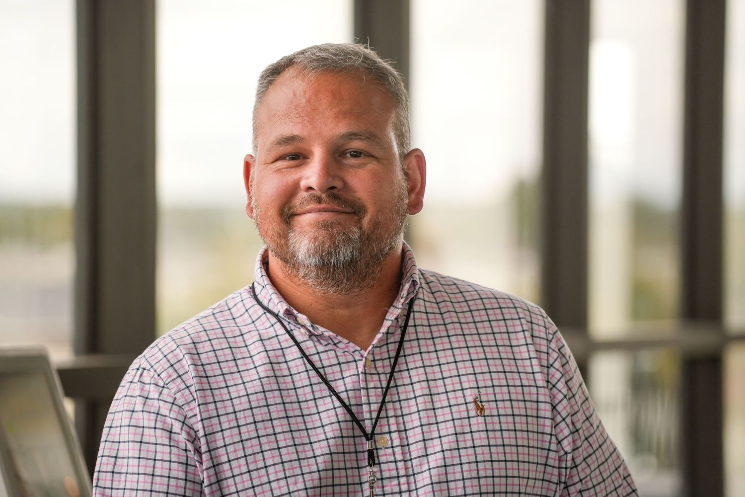 Professional headshots taken against neutral background at corporate event.