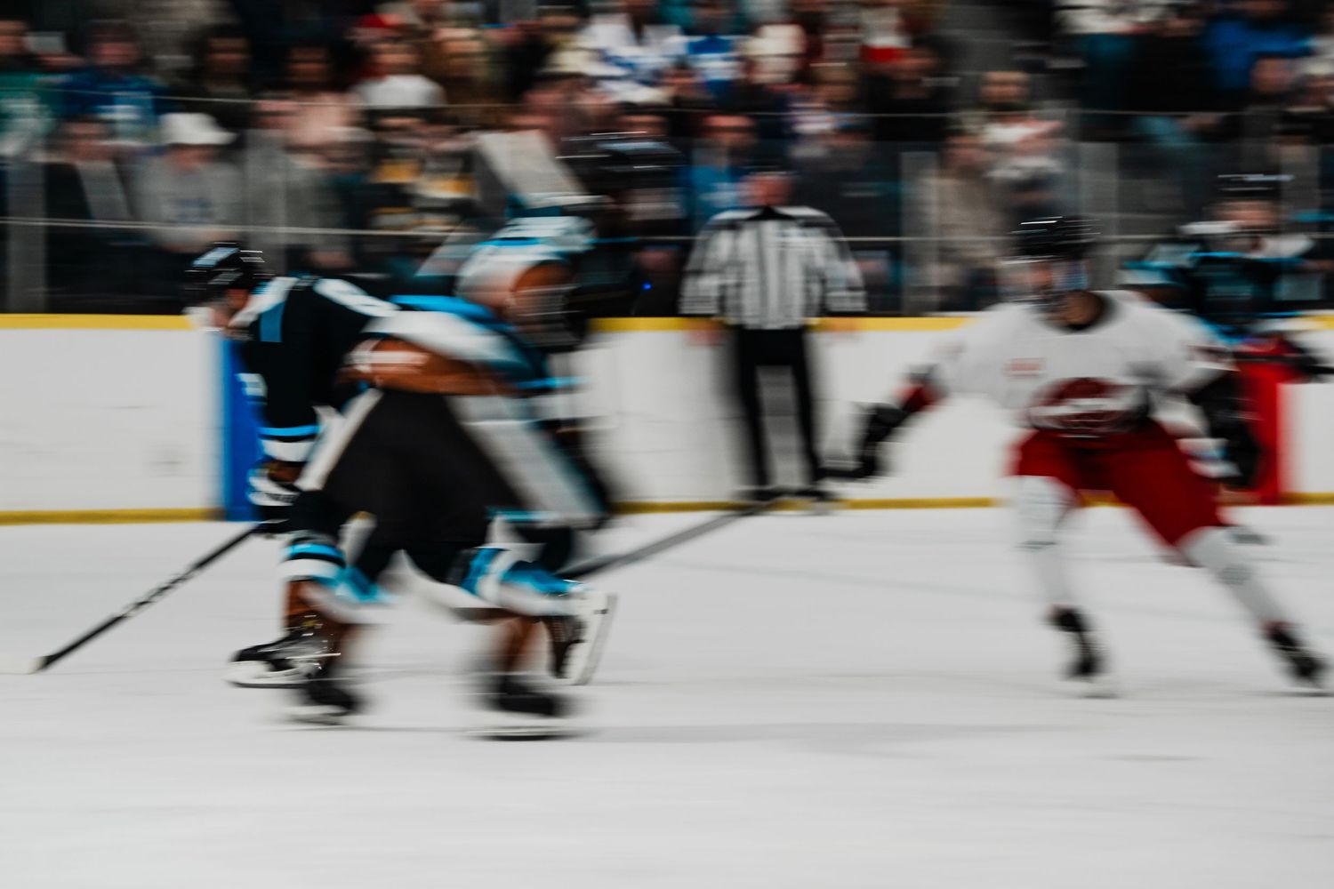 Motion blur of hockey players skating during intense game action.