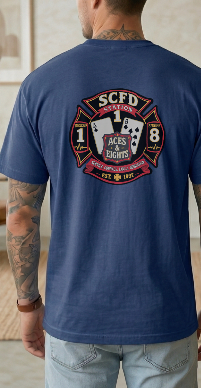 Navy blue SCFD Station 1 Aces & Eights firefighter t-shirt with Maltese cross logo, EST. 1997, worn by tattooed man.