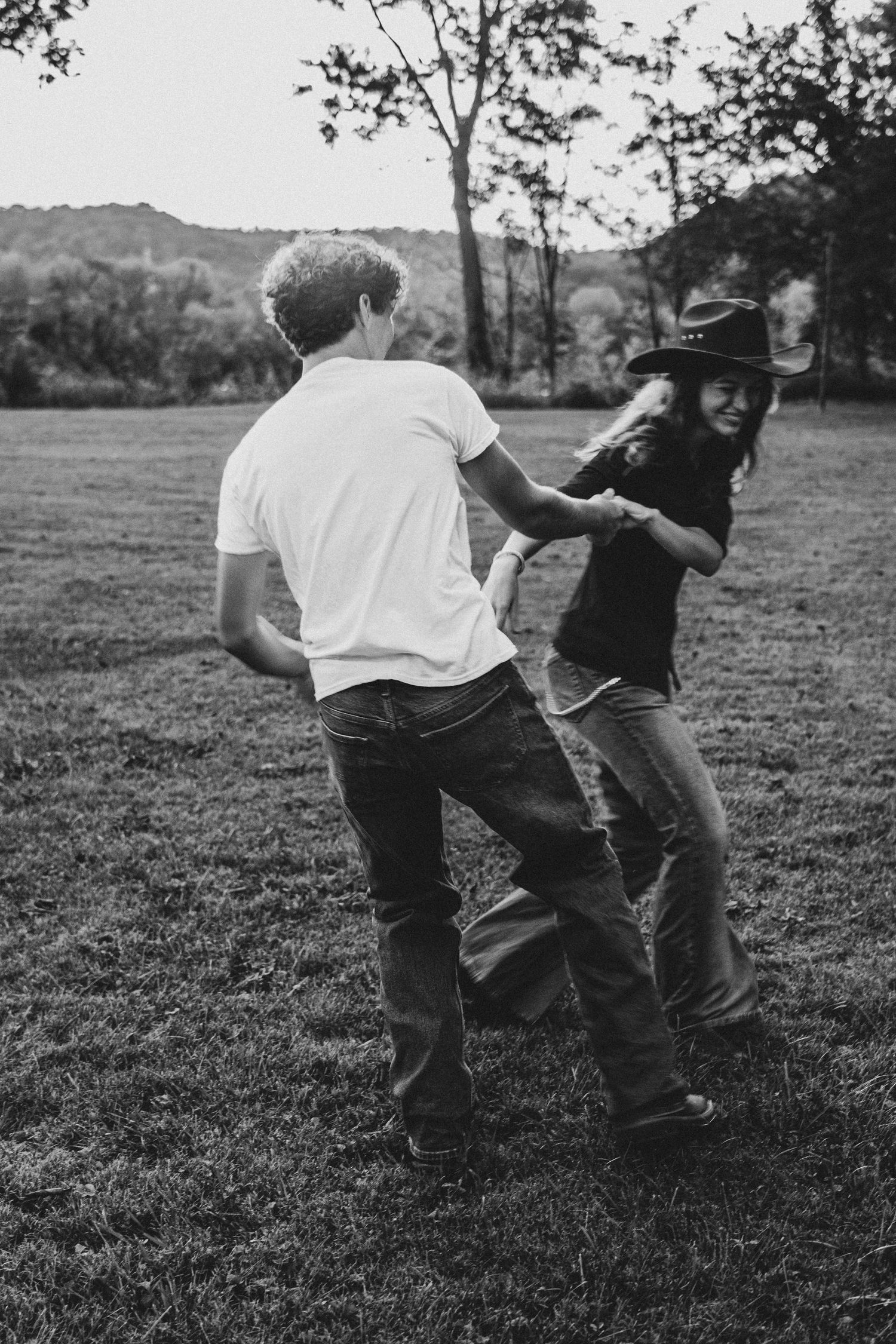 Black and white photo sequence of playful interaction in an open field.