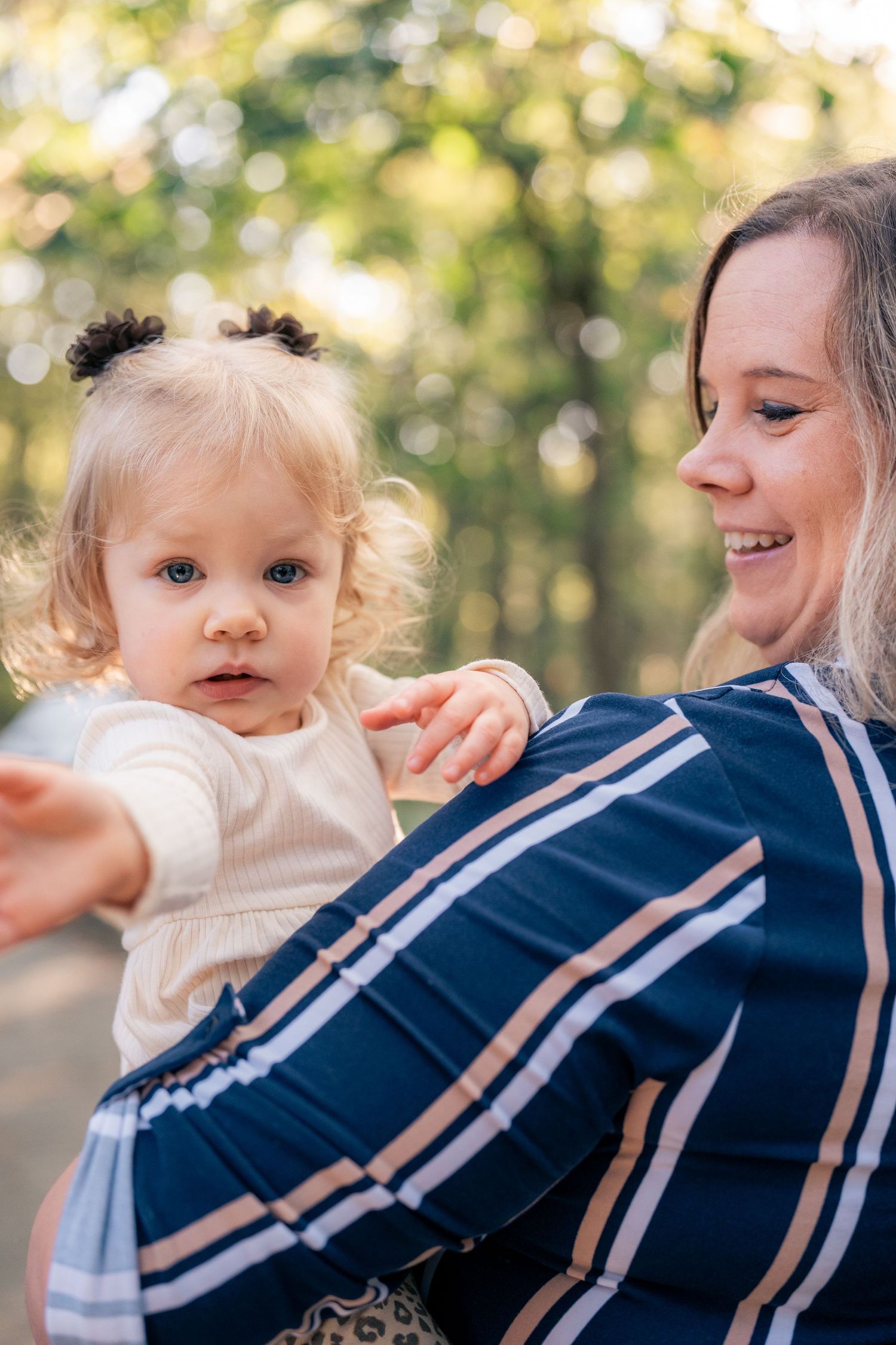 Close-up sequence showing joyful interaction between adult and child in navy striped clothing.