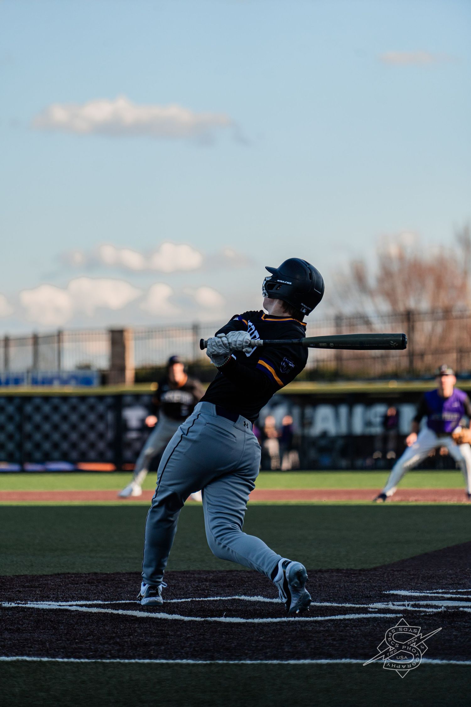 Baseball player in batting stance prepares to hit at home plate during a game.