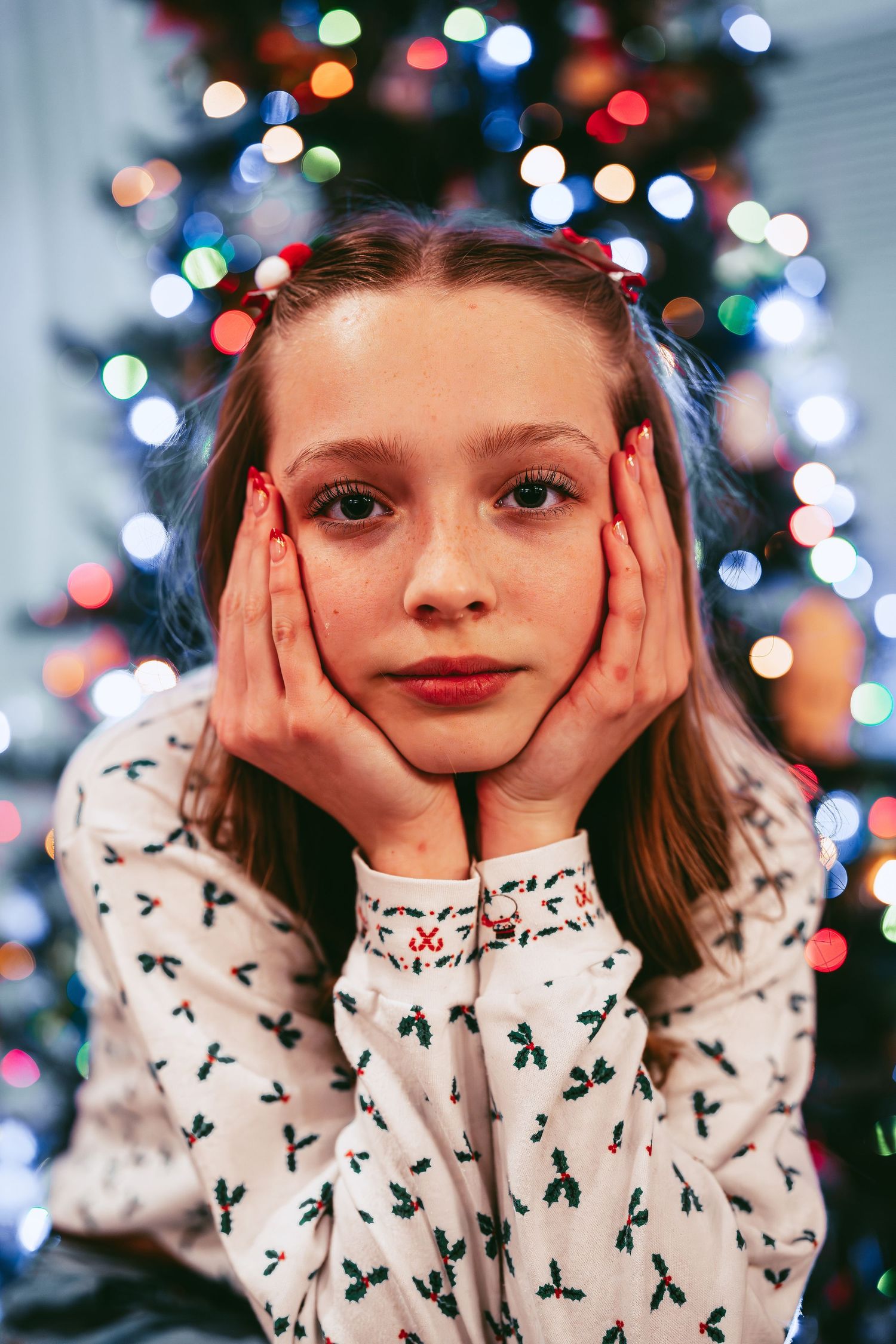 A festive holiday portrait with colorful Christmas lights bokeh in the background.