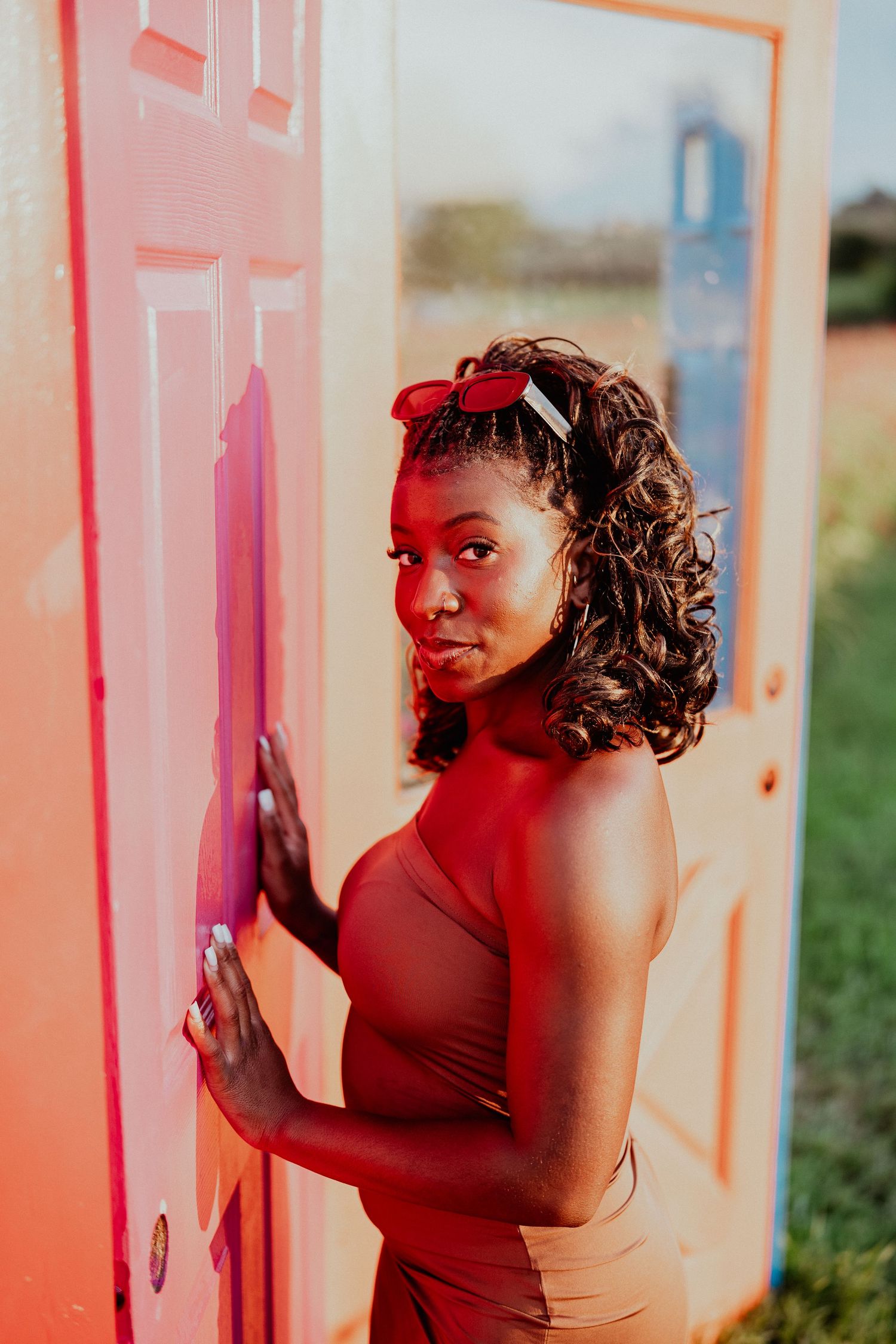 Dramatic portrait series with red lighting effects creating a moody atmosphere.