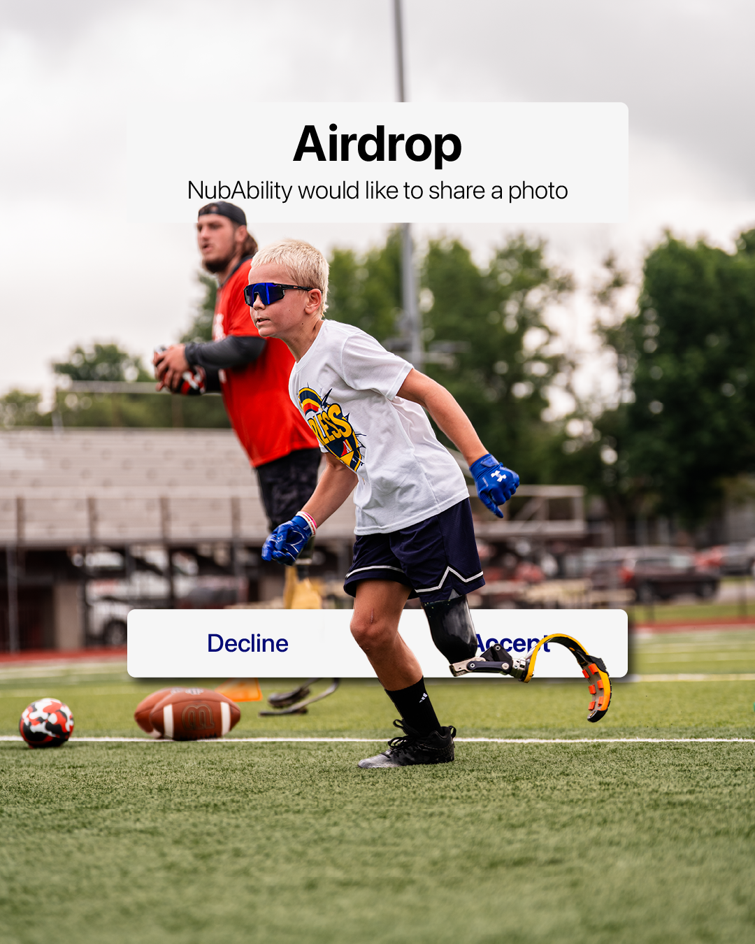 Football player in action on artificial turf field with ball in motion.