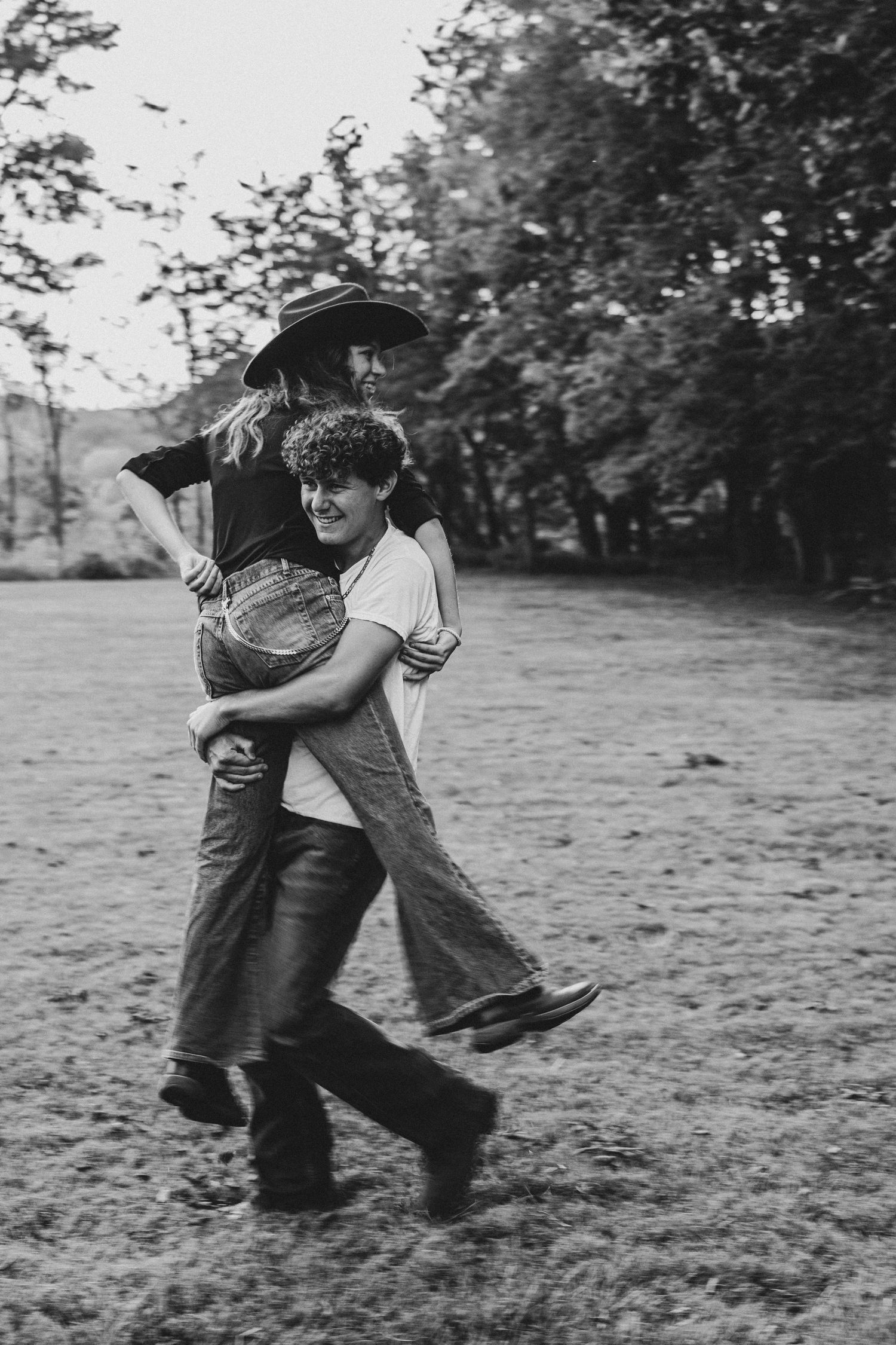 Black and white sequence showing playful movement and interaction outdoors.