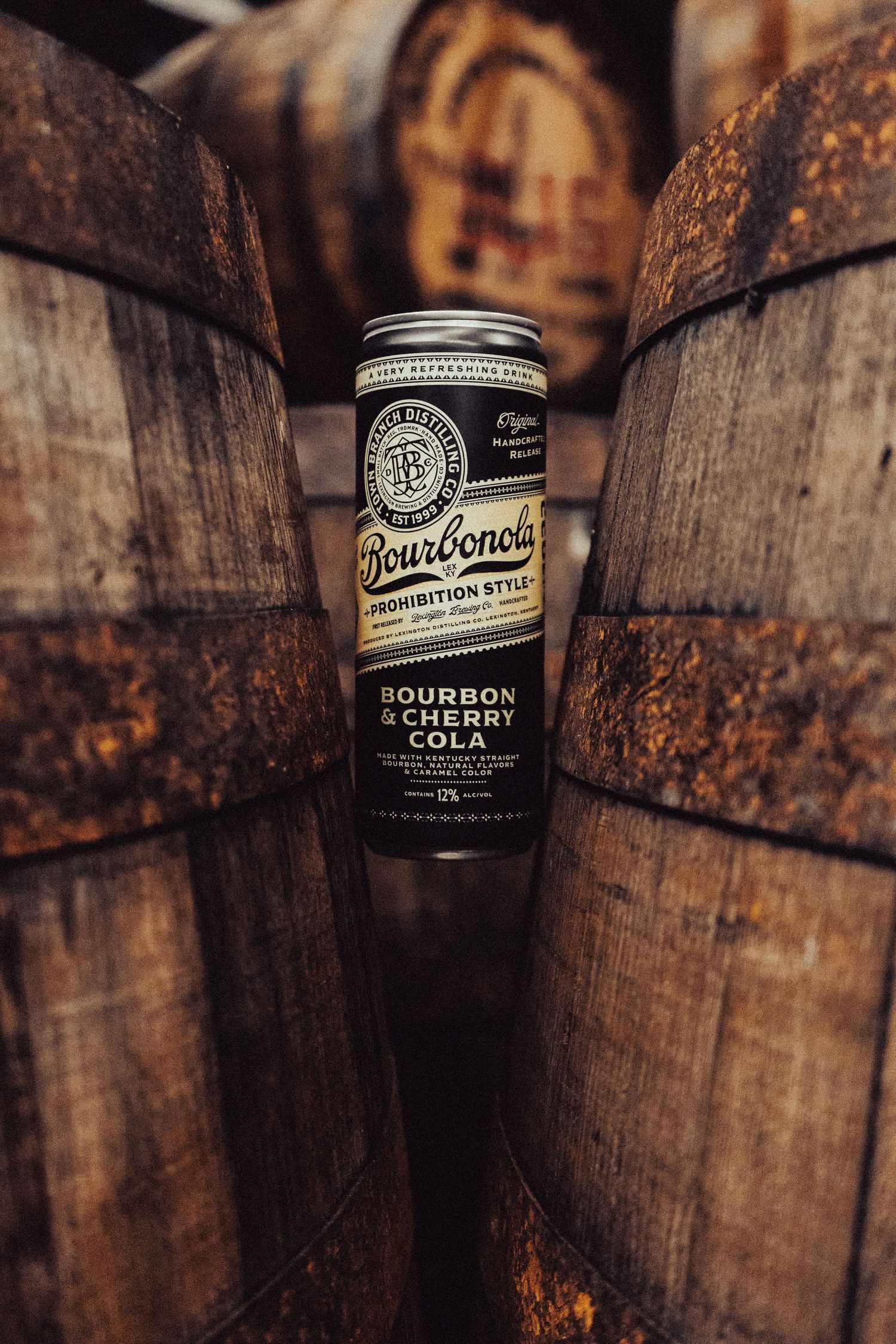 Bourbon barrel aging in a rustic wooden warehouse with vintage bottle labels visible.
