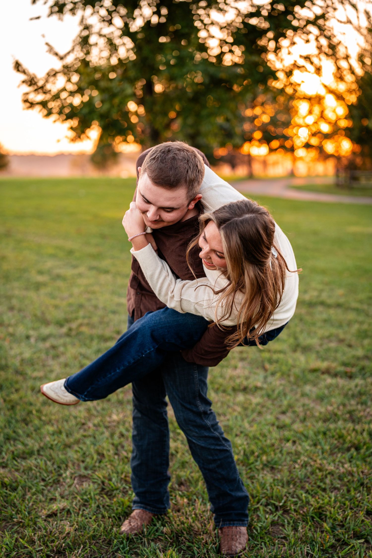 A playful piggyback ride captured during golden hour in a grassy field.