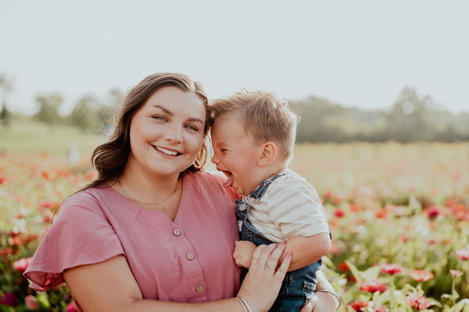 Sweet family photos taken in a vibrant sunflower garden during golden hour.