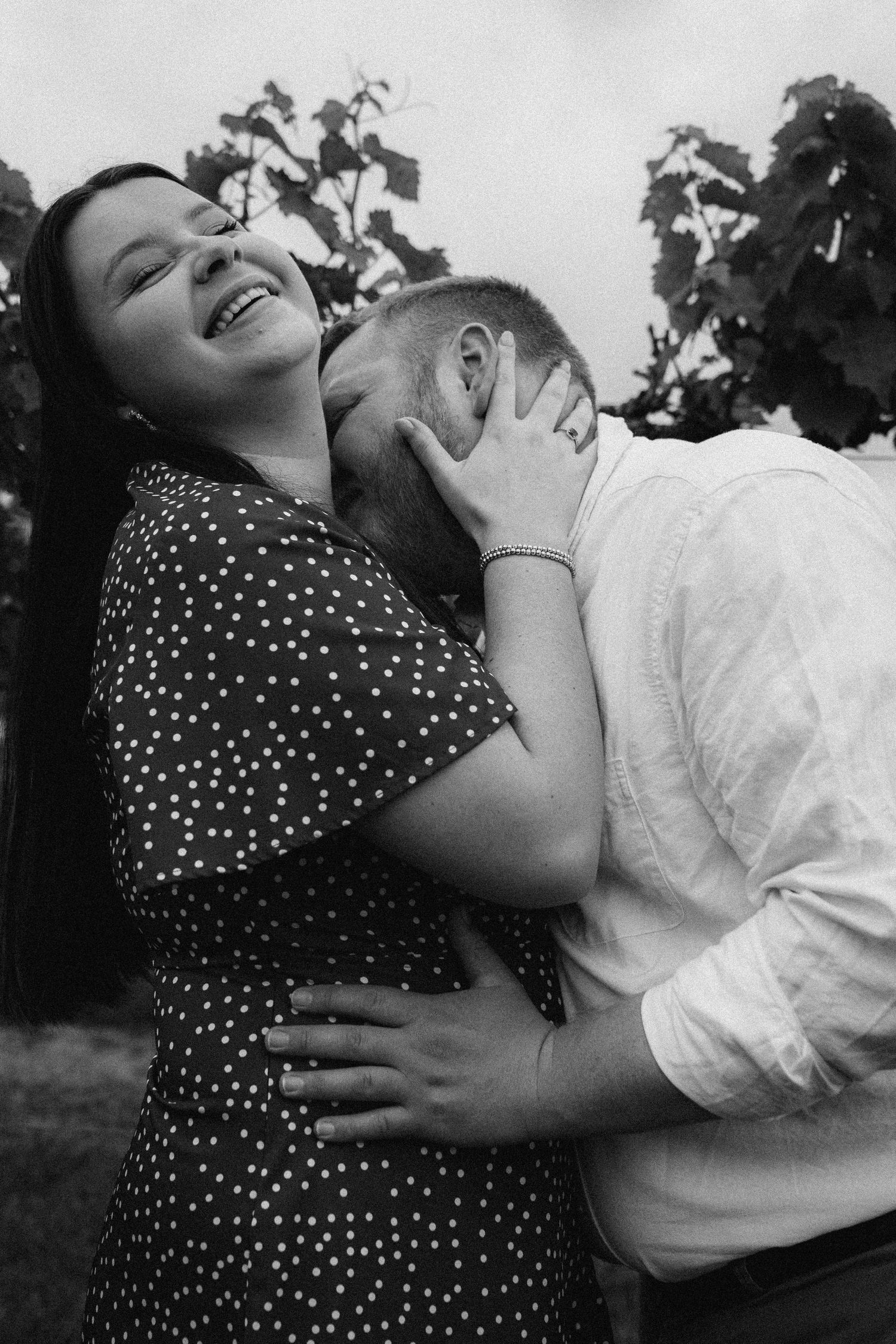 A joyful black and white moment captured in a vineyard setting.
