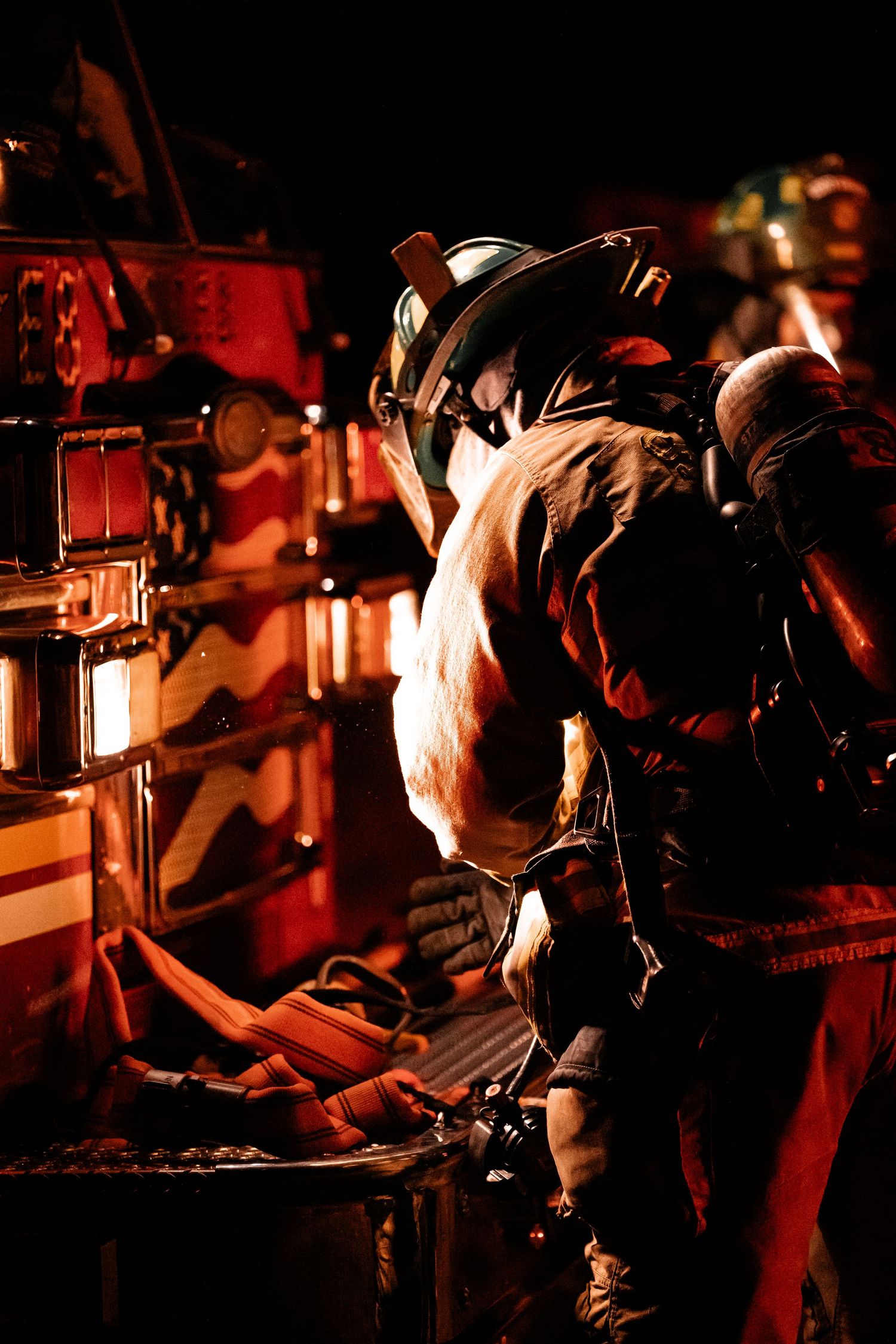 Close-up shots of film production crew working with camera equipment in dark red lighting.