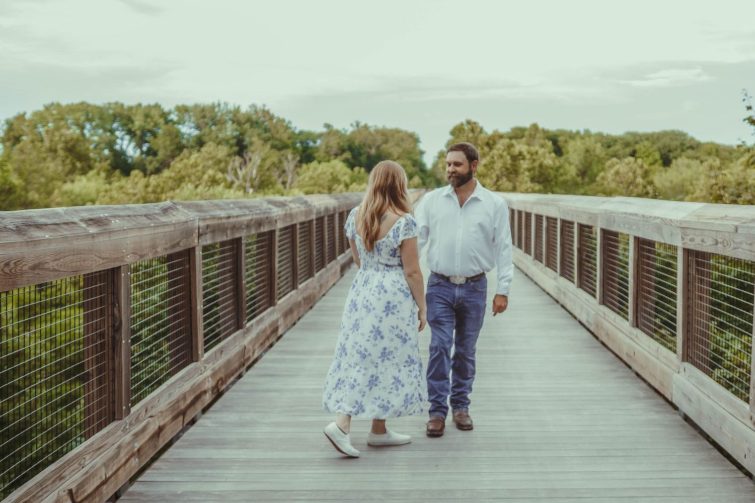 couple walking on Kickapoo rail trail bridge