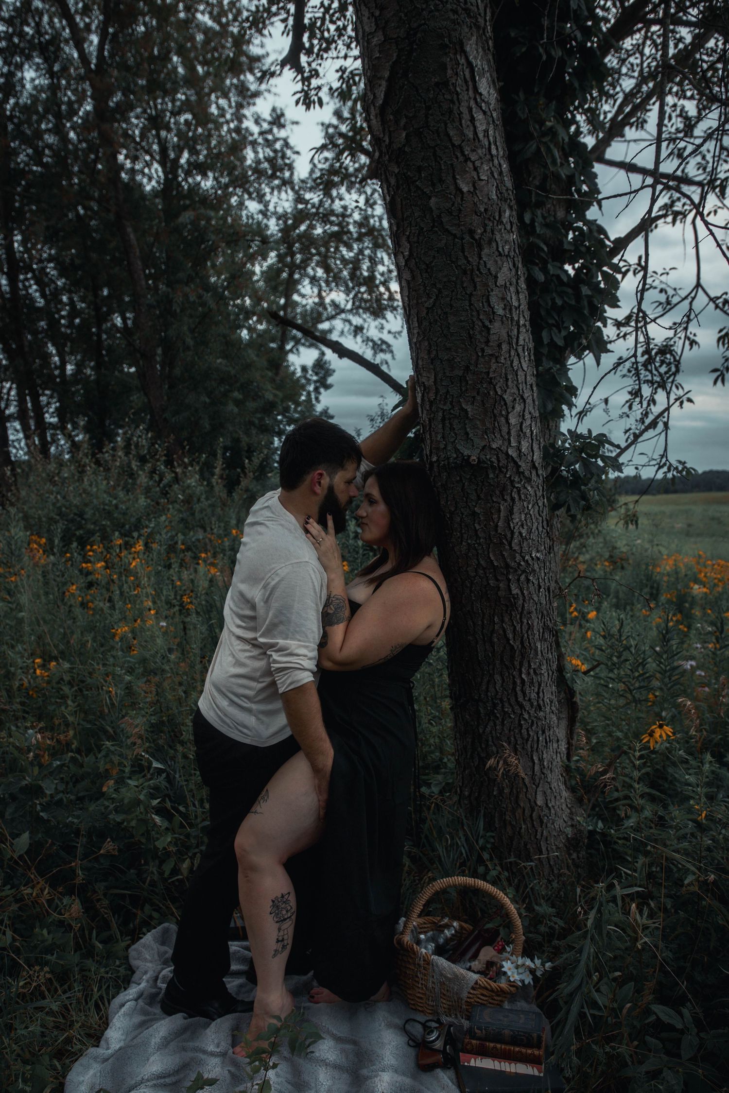 moody couples picnic in a black eye Susan field