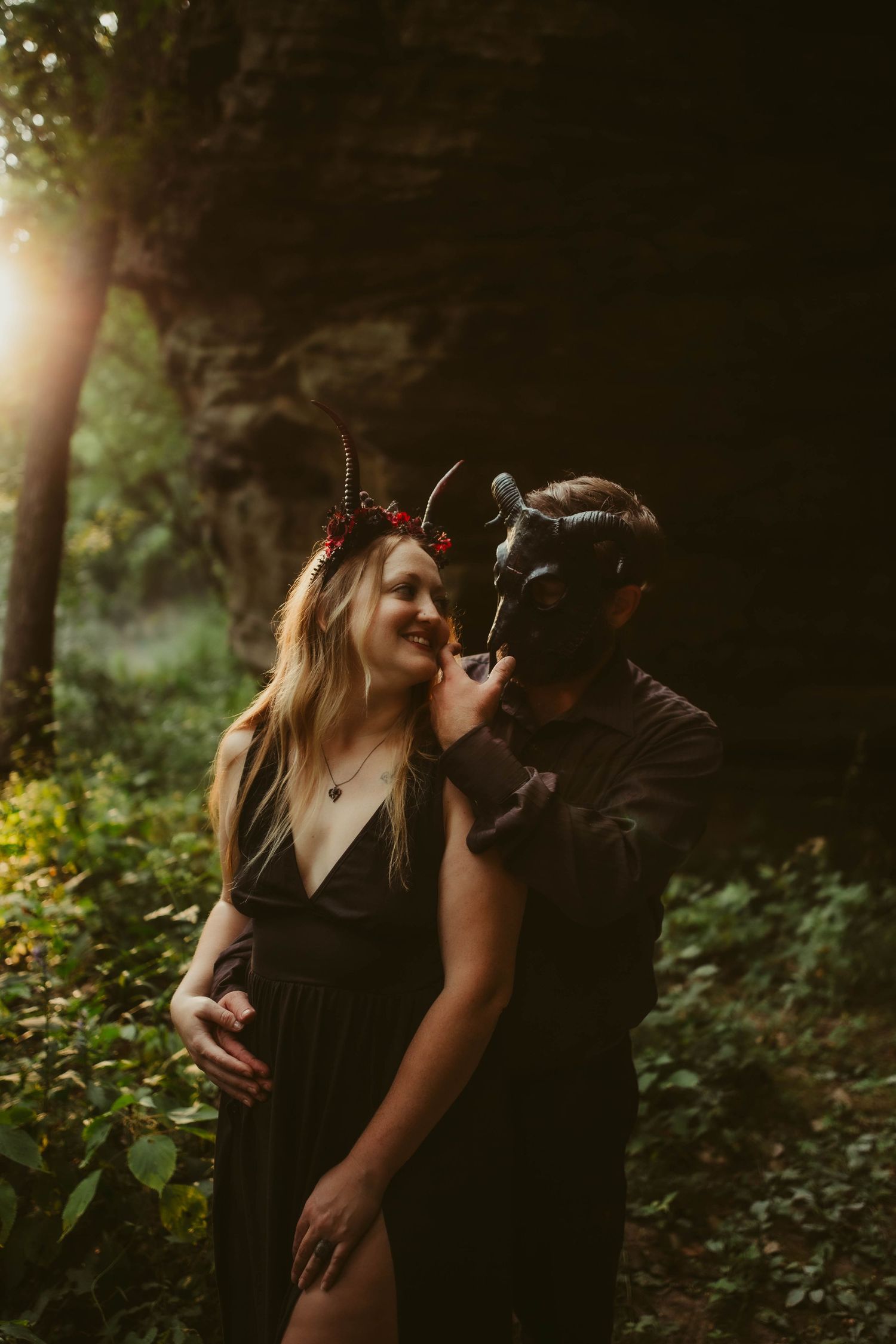 persephone and hades in the middle of the woods with sun light glow