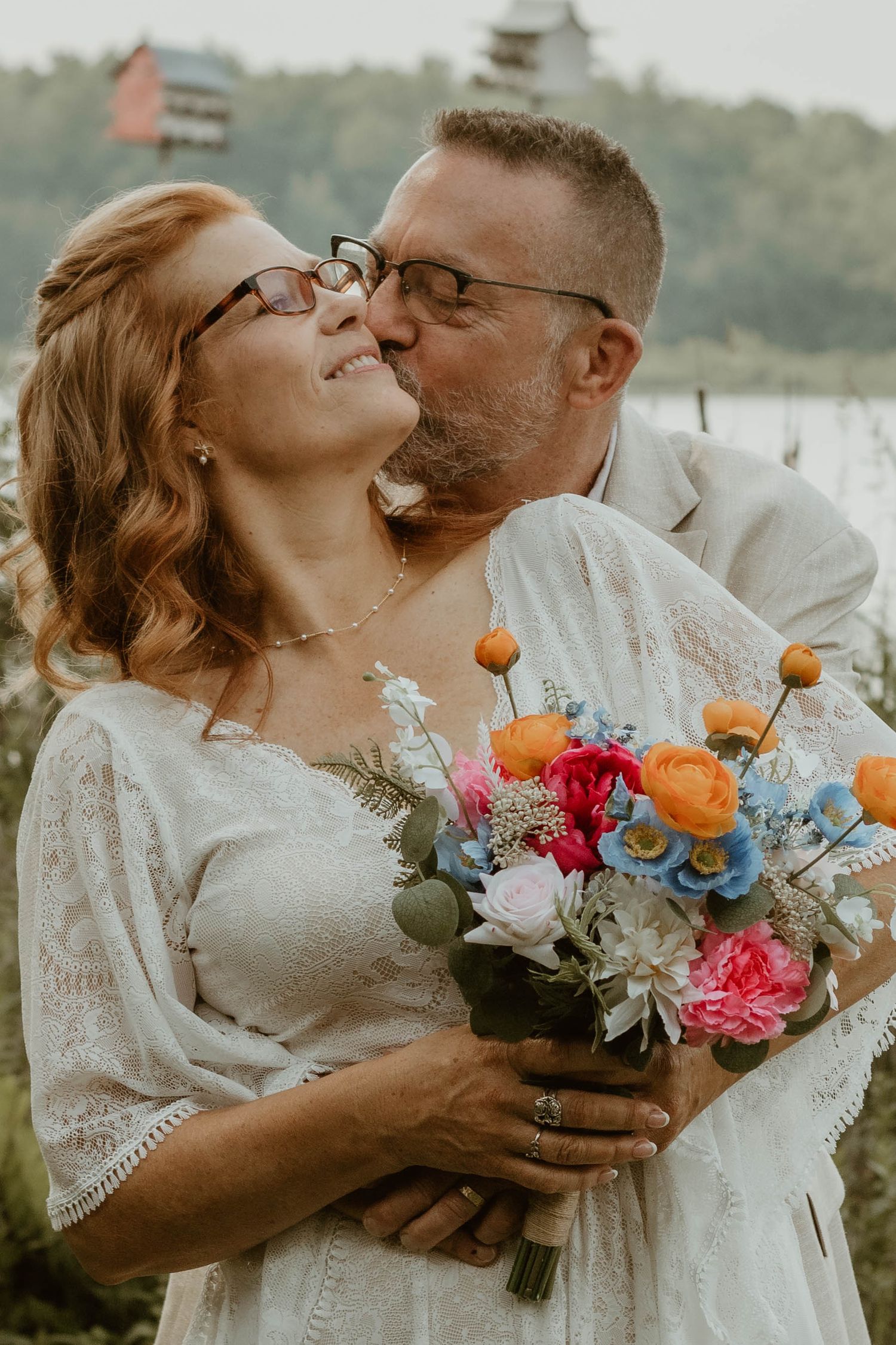 bride and groom with bright colored flowers