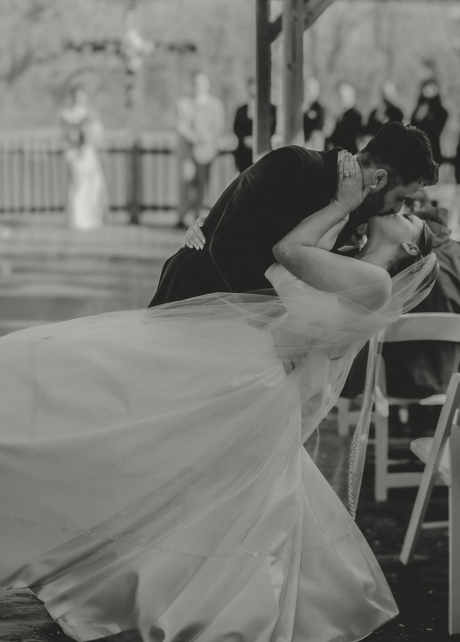 bride and groom kiss and dip
