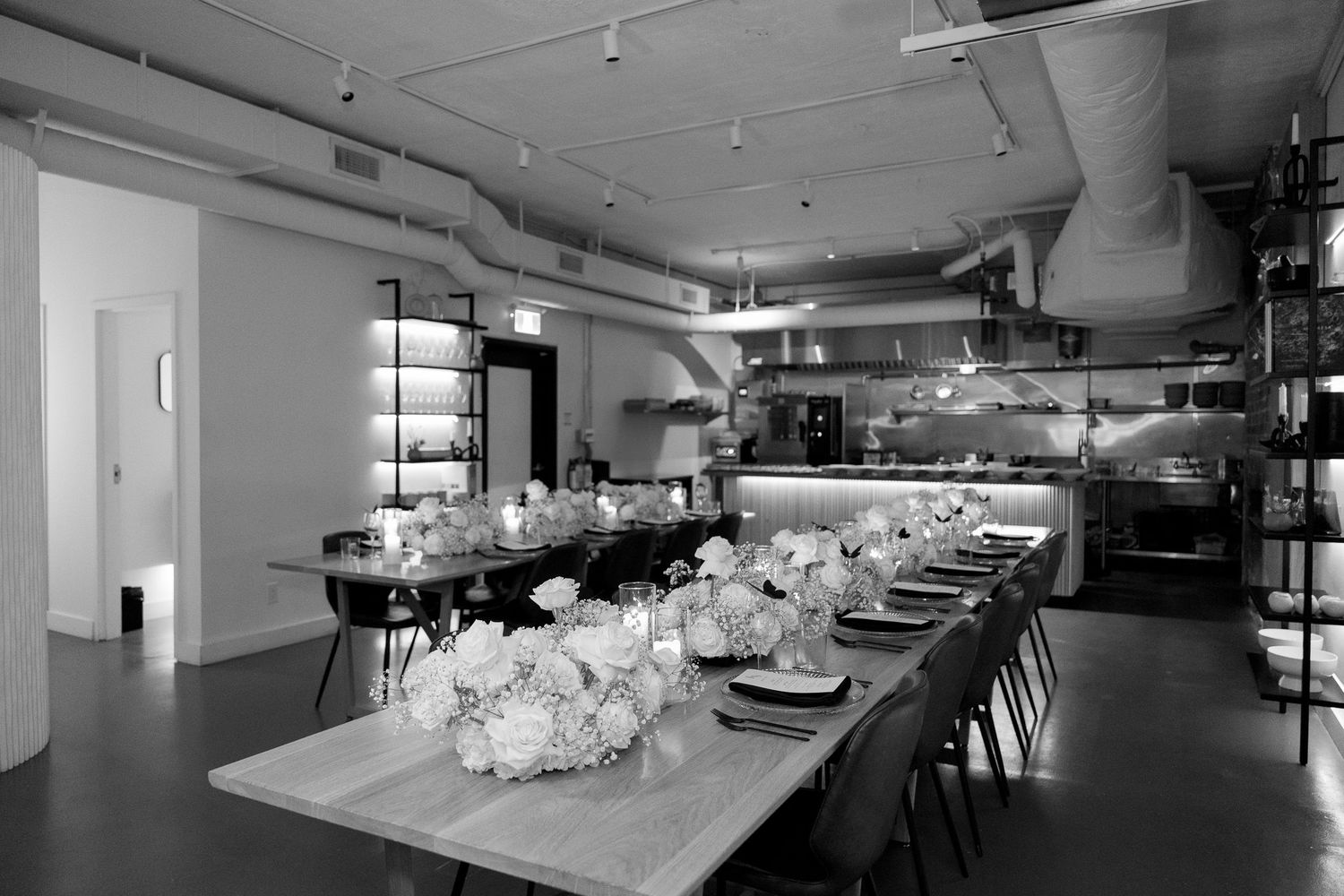 Spacious wedding reception venue with long tables and minimalist decor.