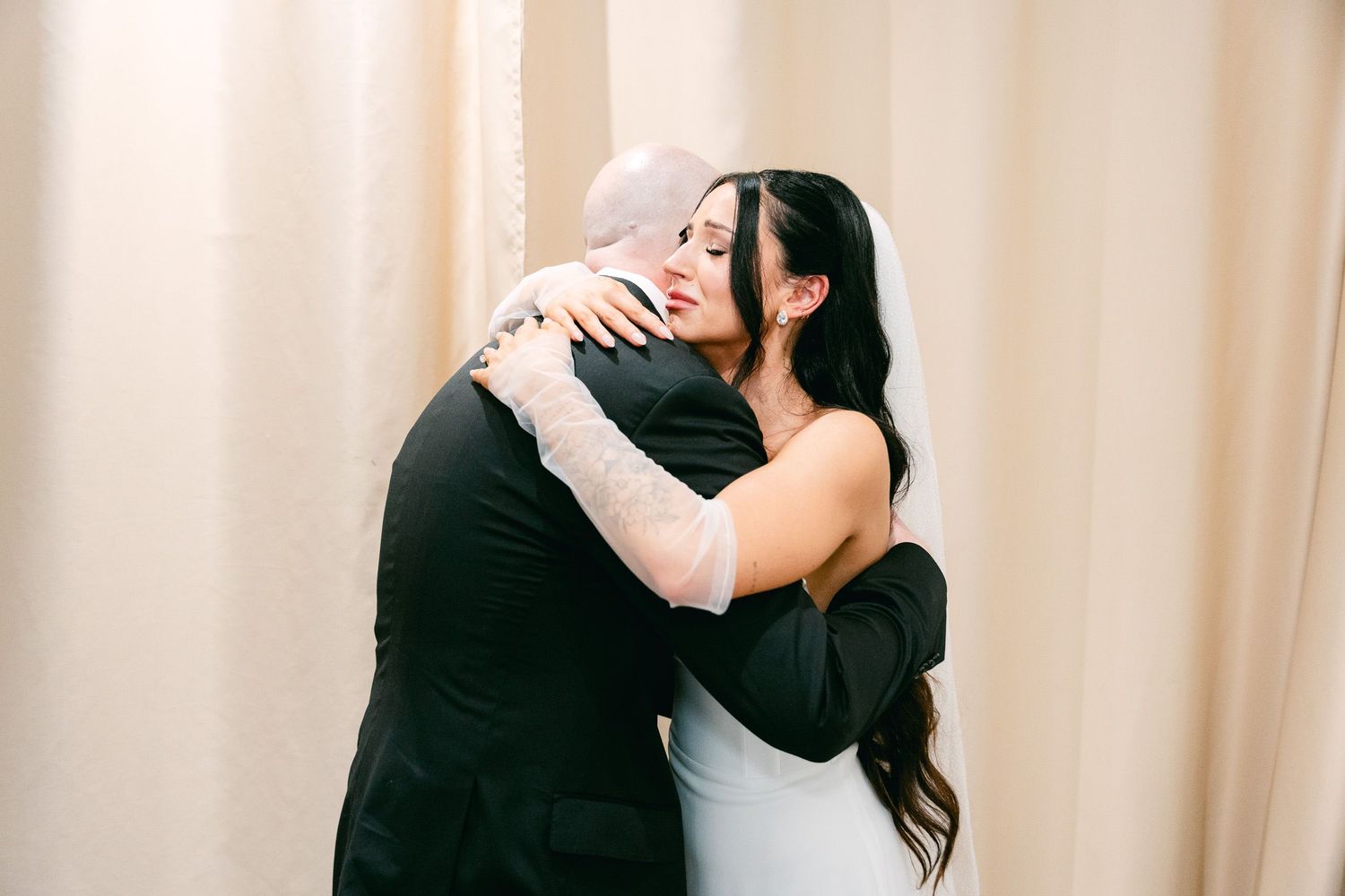 Emotional wedding moments shared between guests in formal attire.