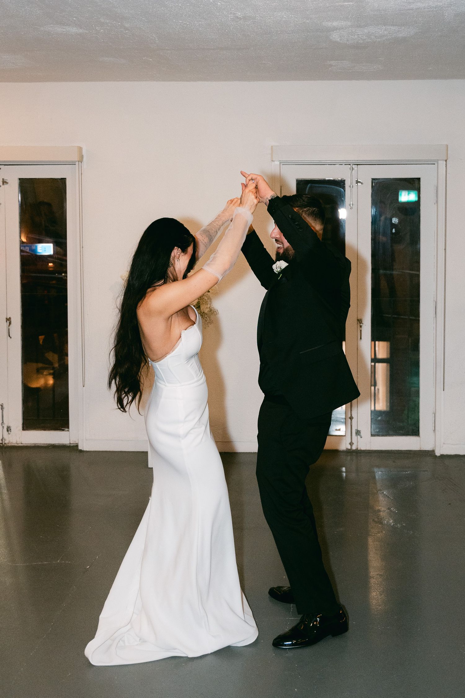 A couple performing an elegant twirl during their wedding dance.